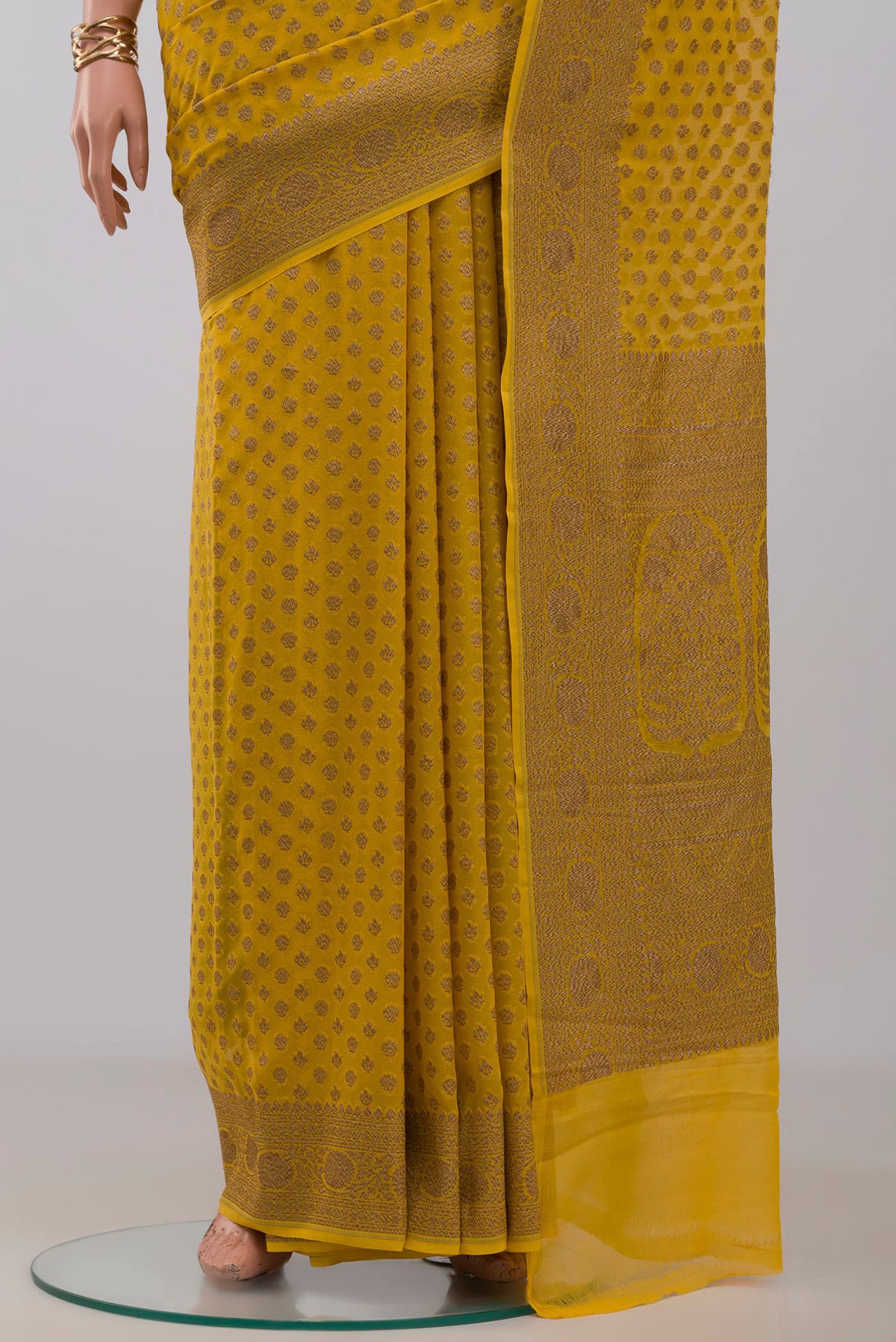 Pleats and pallu of Yellow Georgette Saree with Fancy on the body and Fancy Border. 