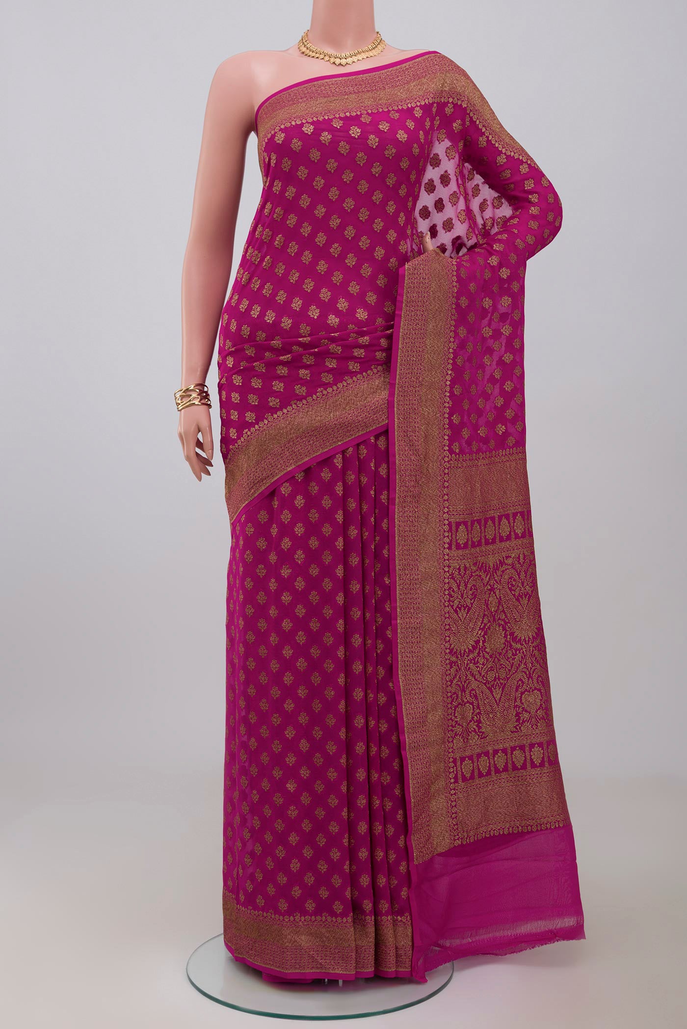 Pink Georgette Saree with Fancy on the body and Fancy Border.  displayed on a mannequin