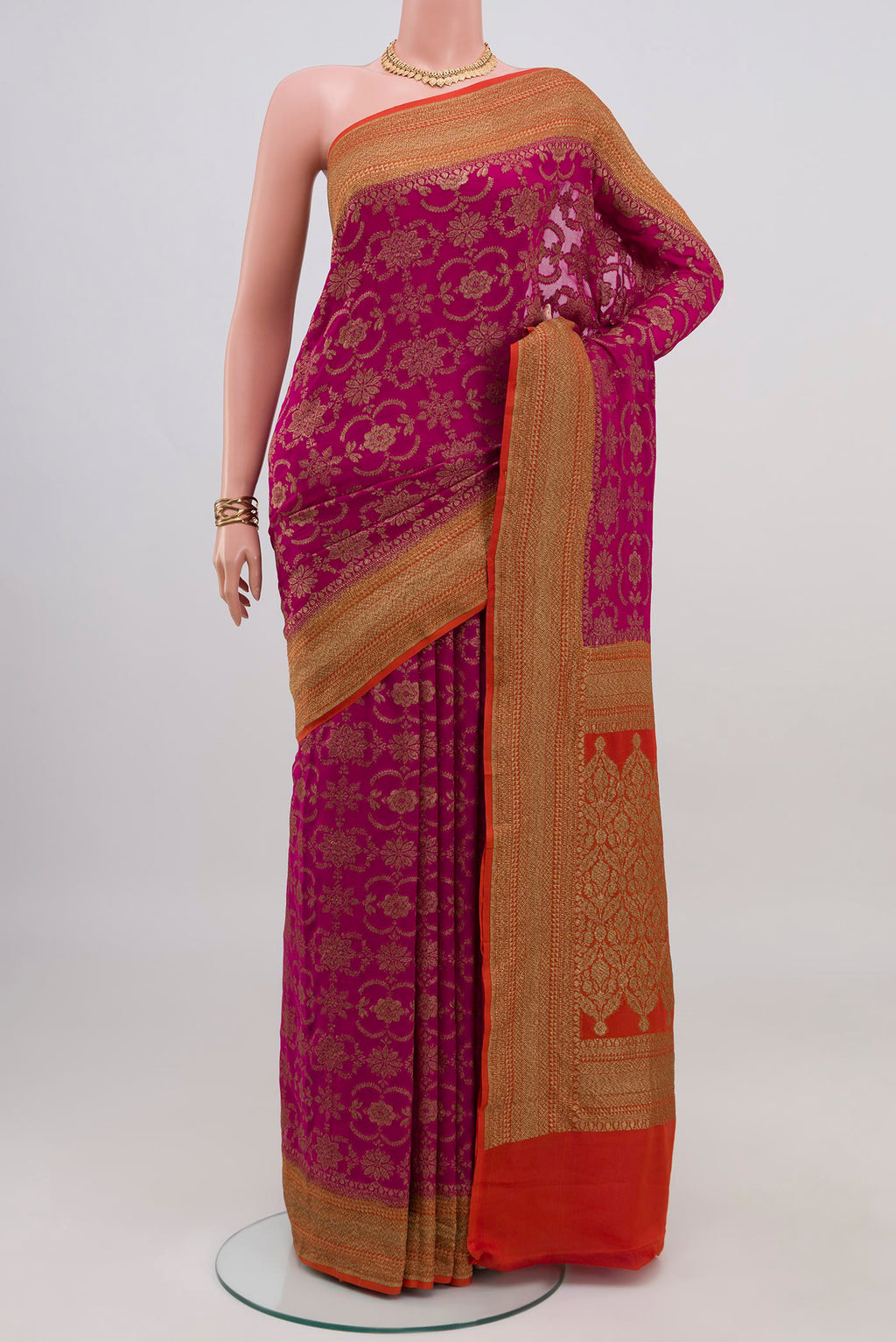 Magenta Banarasi Georgette Saree with Zari Brocade on the body and Zari Border.  displayed on a mannequin