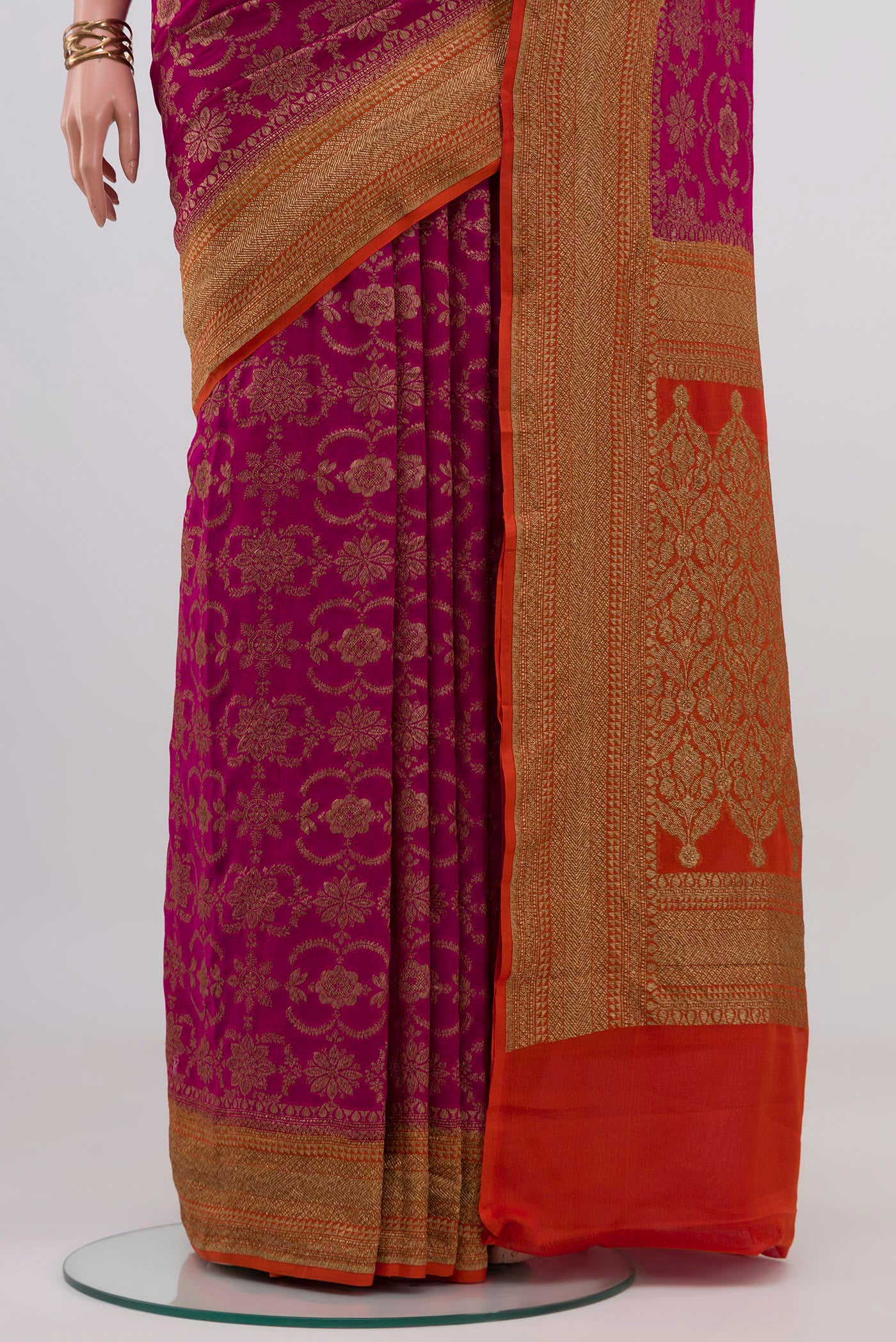 Pleats and pallu of Magenta Banarasi Georgette Saree with Zari Brocade on the body and Zari Border. 