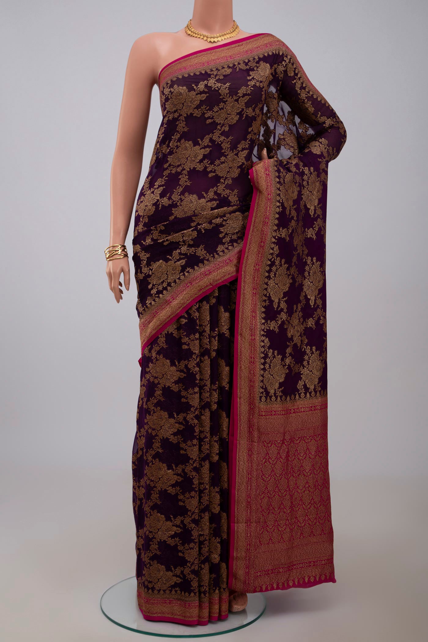 Purple Georgette Saree with Fancy on the body and Zari Border.  displayed on a mannequin