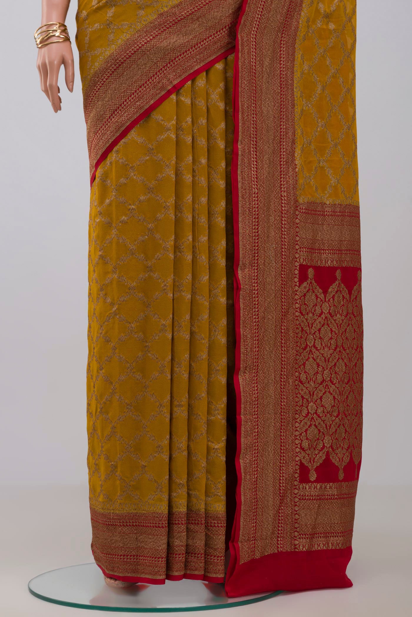 Pleats and pallu of Yellow Georgette Saree with Fancy on the body and Zari Border. 