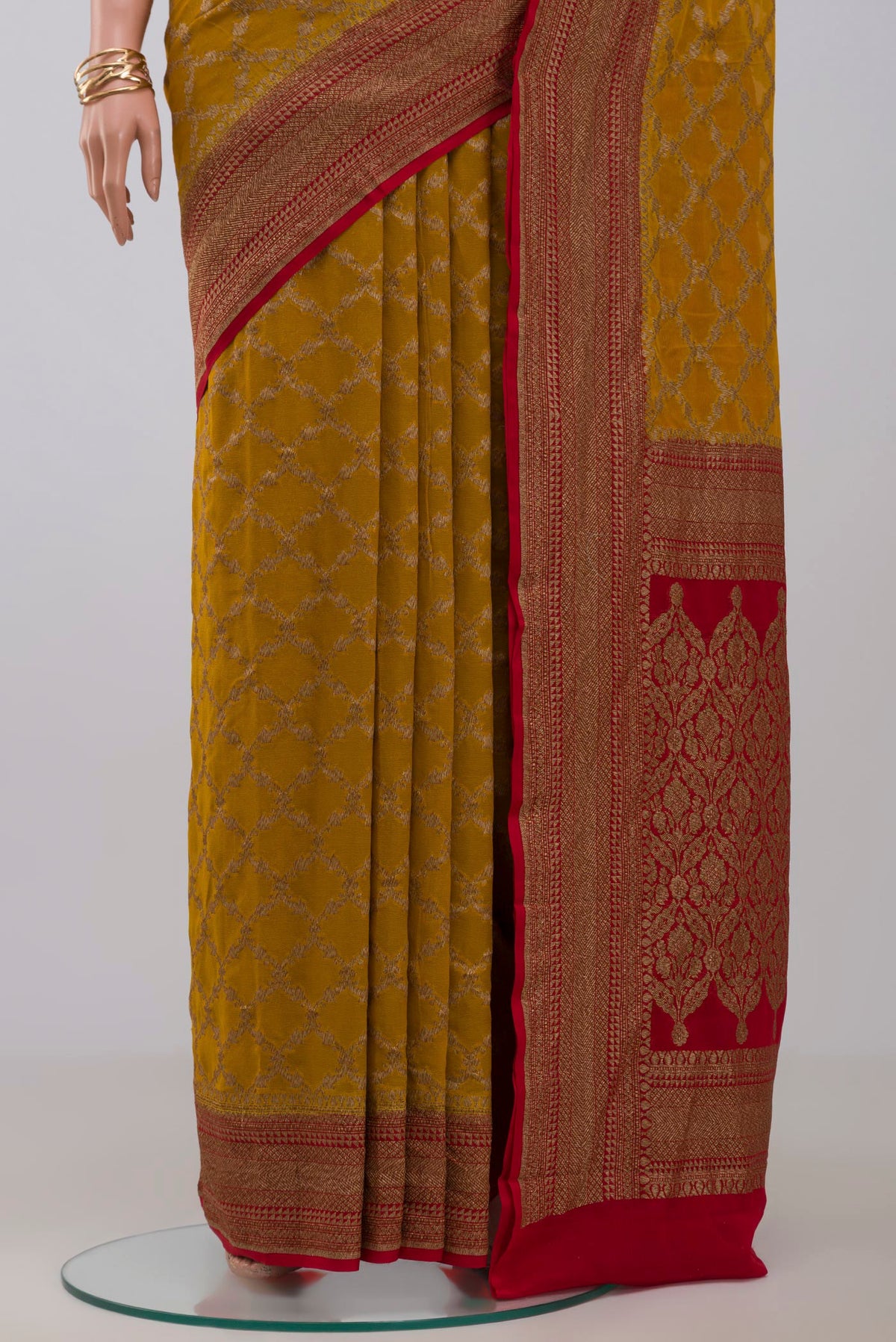 Pleats and pallu of Yellow Georgette Saree with Fancy on the body and Zari Border. 