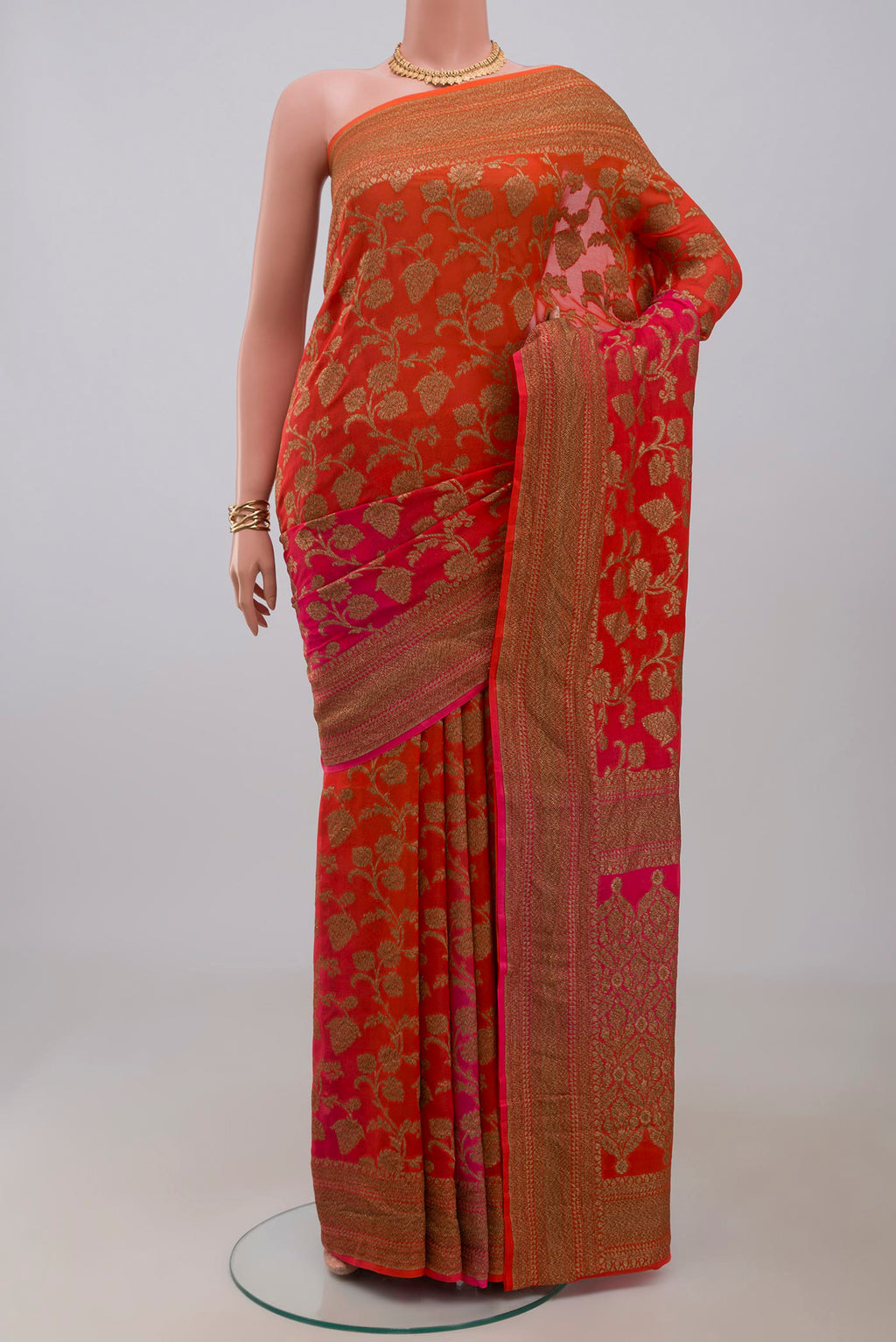 Orange Georgette Saree with Fancy on the body and Fancy Border.  displayed on a mannequin