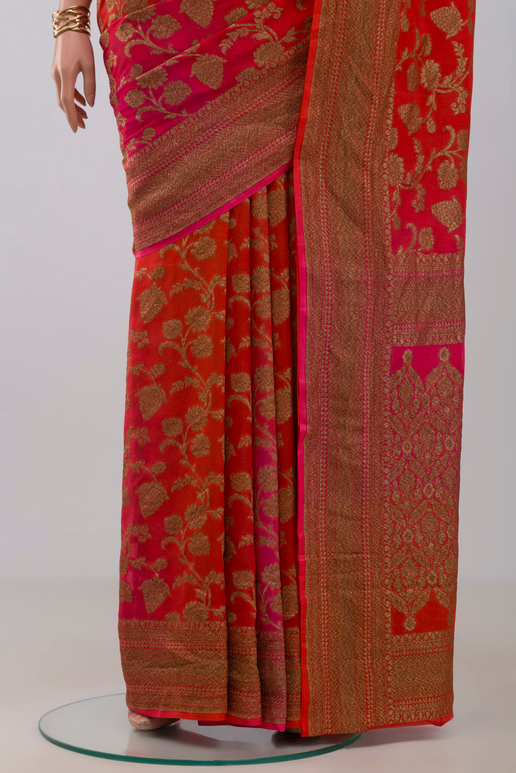 Pleats and pallu of Orange Georgette Saree with Fancy on the body and Fancy Border. 