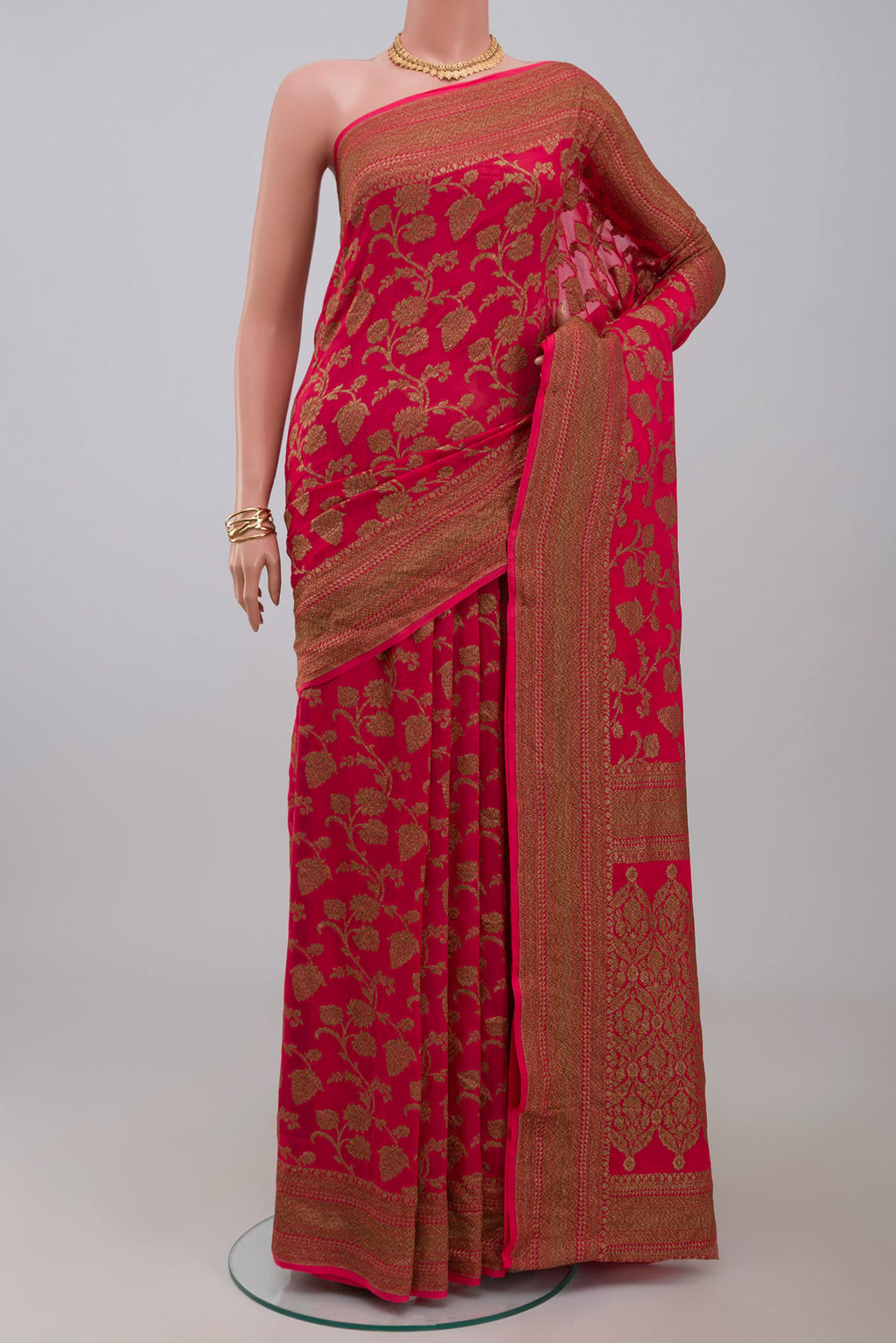 Pink Georgette Saree with Fancy on the body and Zari Border.  displayed on a mannequin
