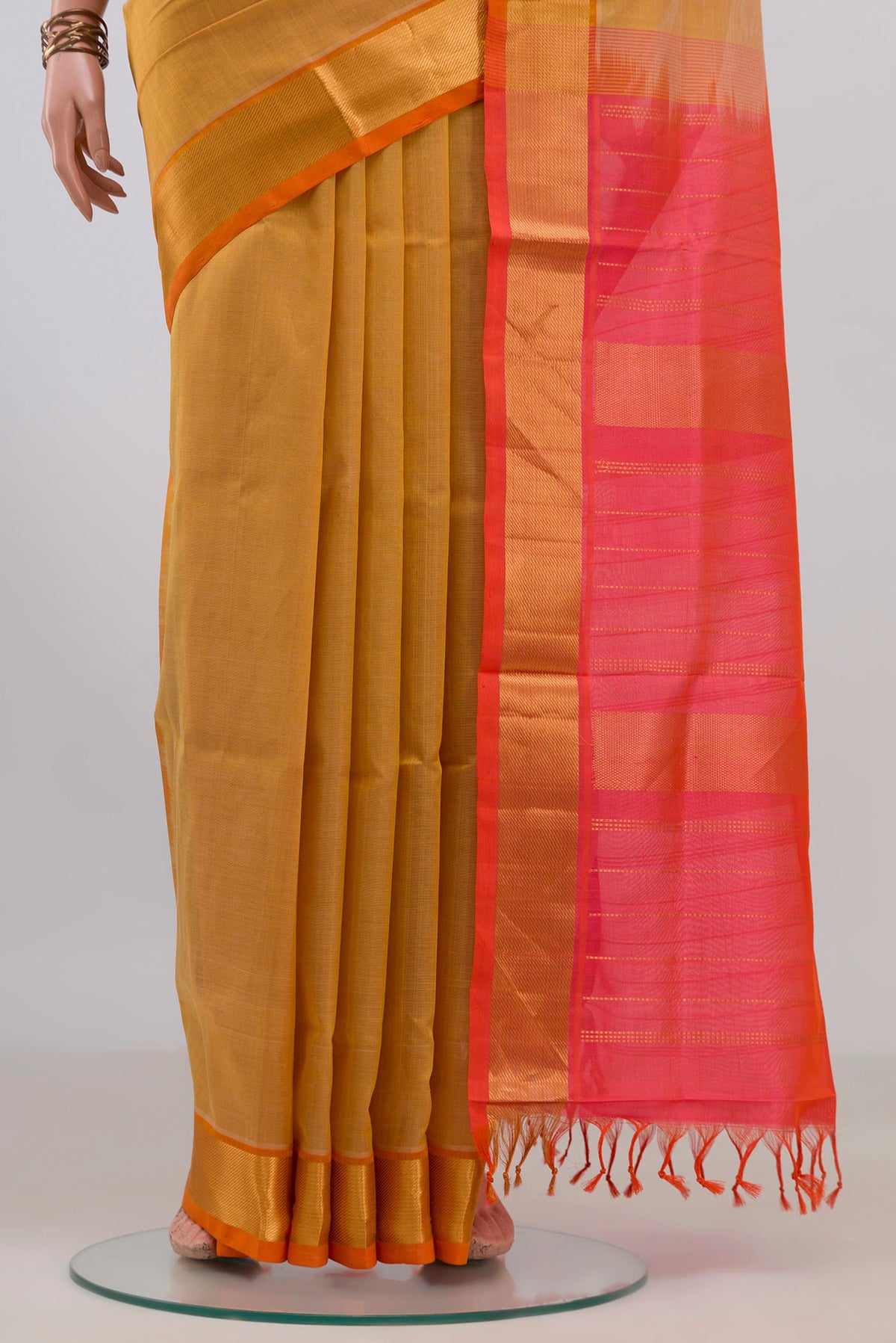 Pleats and pallu of Yellow Silk Cotton Saree with Plain Body and Zari Border. 