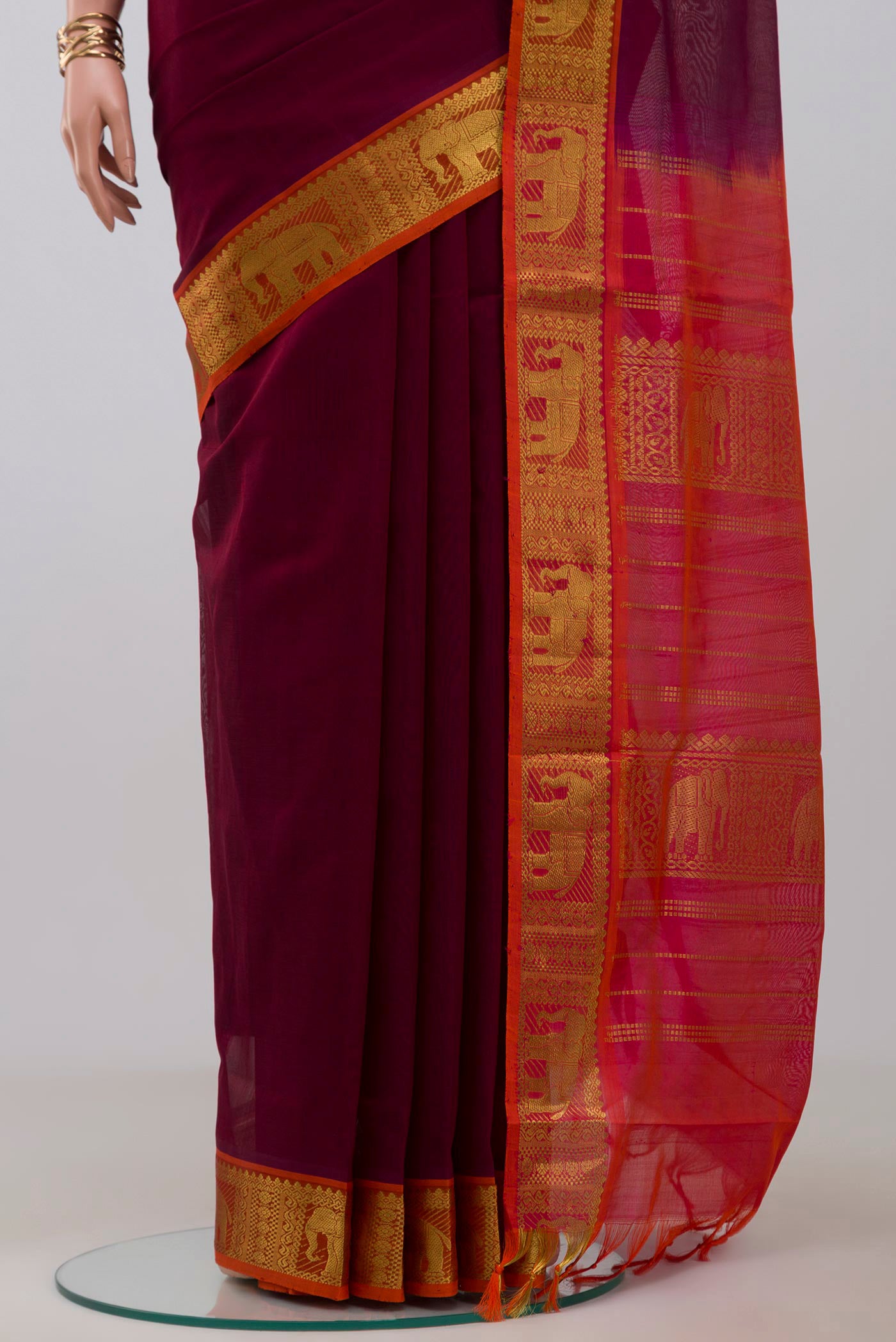 Pleats and pallu of Maroon Silk Cotton Saree with Plain Body and Zari Border. 
