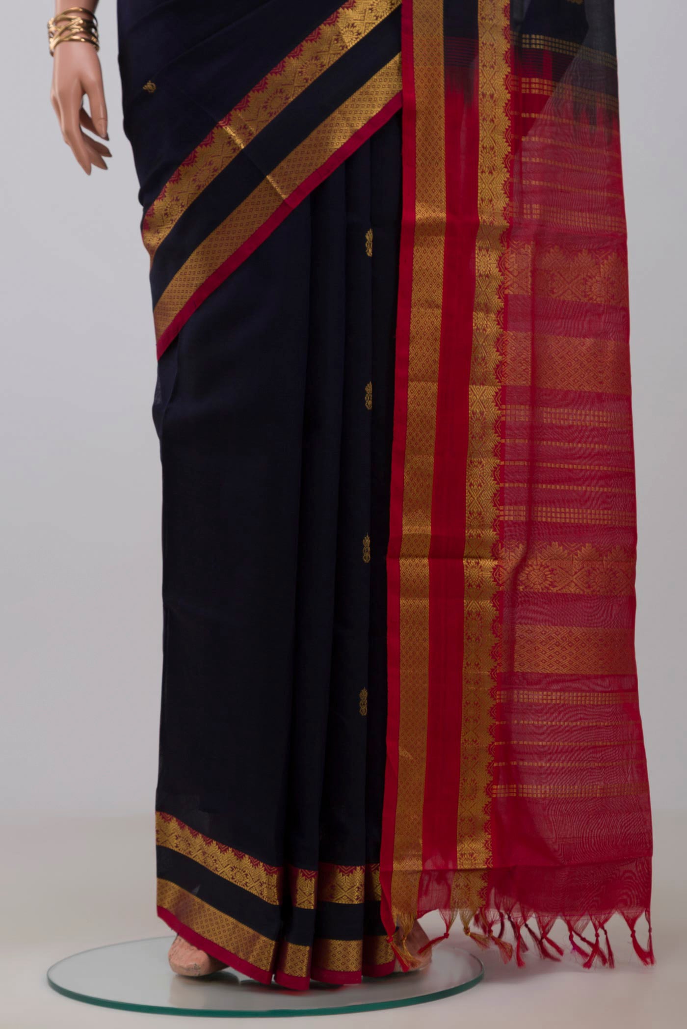 Pleats and pallu of Navy Blue Silk Cotton Saree with Zari Butta on the body and Zari Border. 