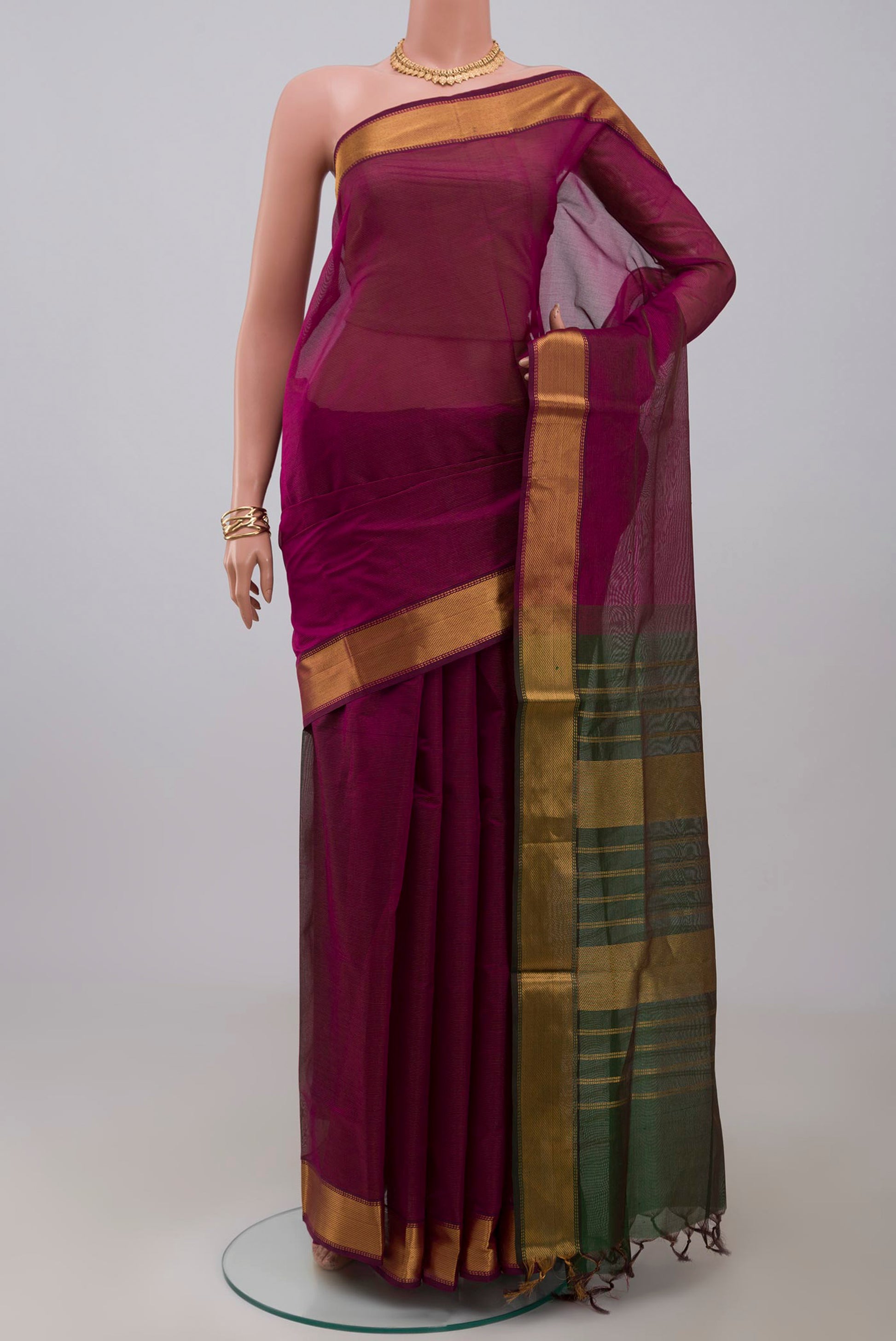 Magenta Coimbatore Silk Cotton Saree with Stripes on the body and Zari Border.  displayed on a mannequin