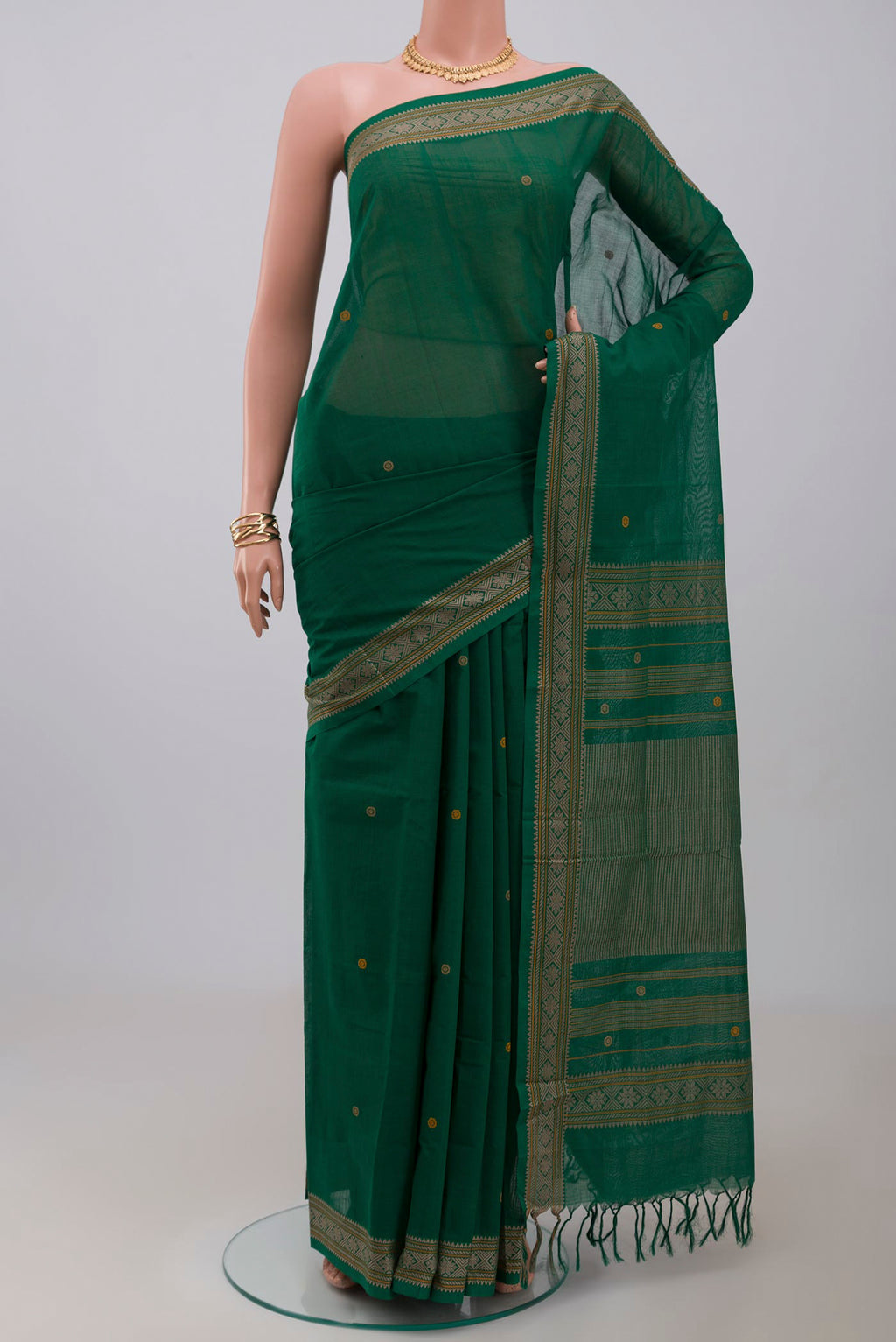 Green Kanchi Cotton Saree with Thread Butta on the body and Thread Border.  displayed on a mannequin
