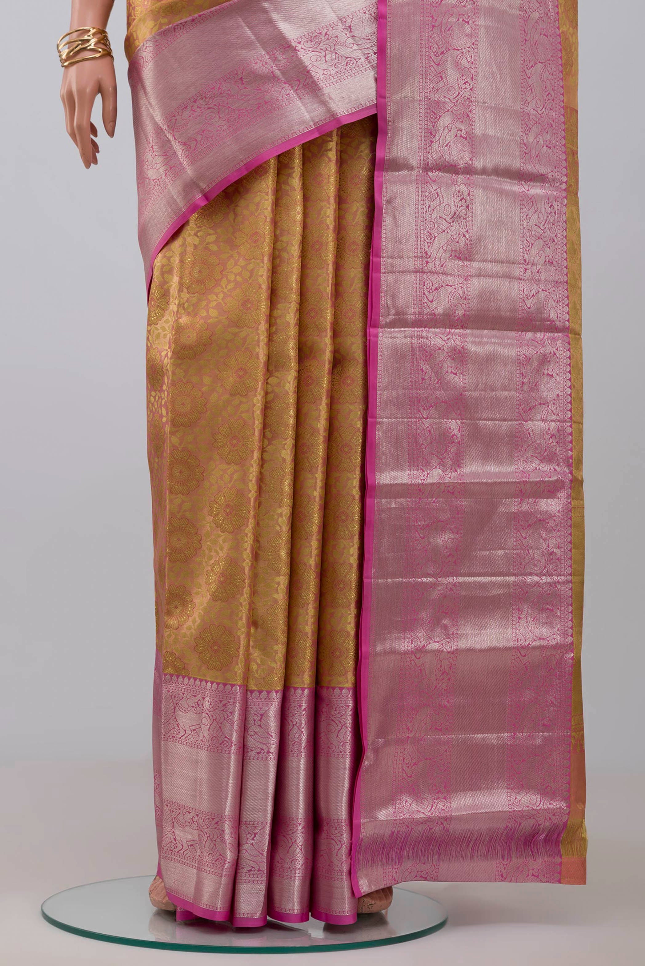Pleats and pallu of Golden Peach Kanchipuram Silk Saree with Zari Brocade on the body and Zari Border. 