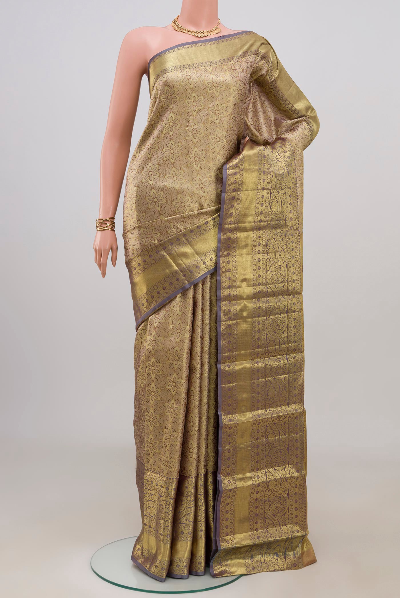 Golden Dual Tone Kanchipuram Tissue Silk Saree with Zari Brocade on the body and Zari Border.  displayed on a mannequin