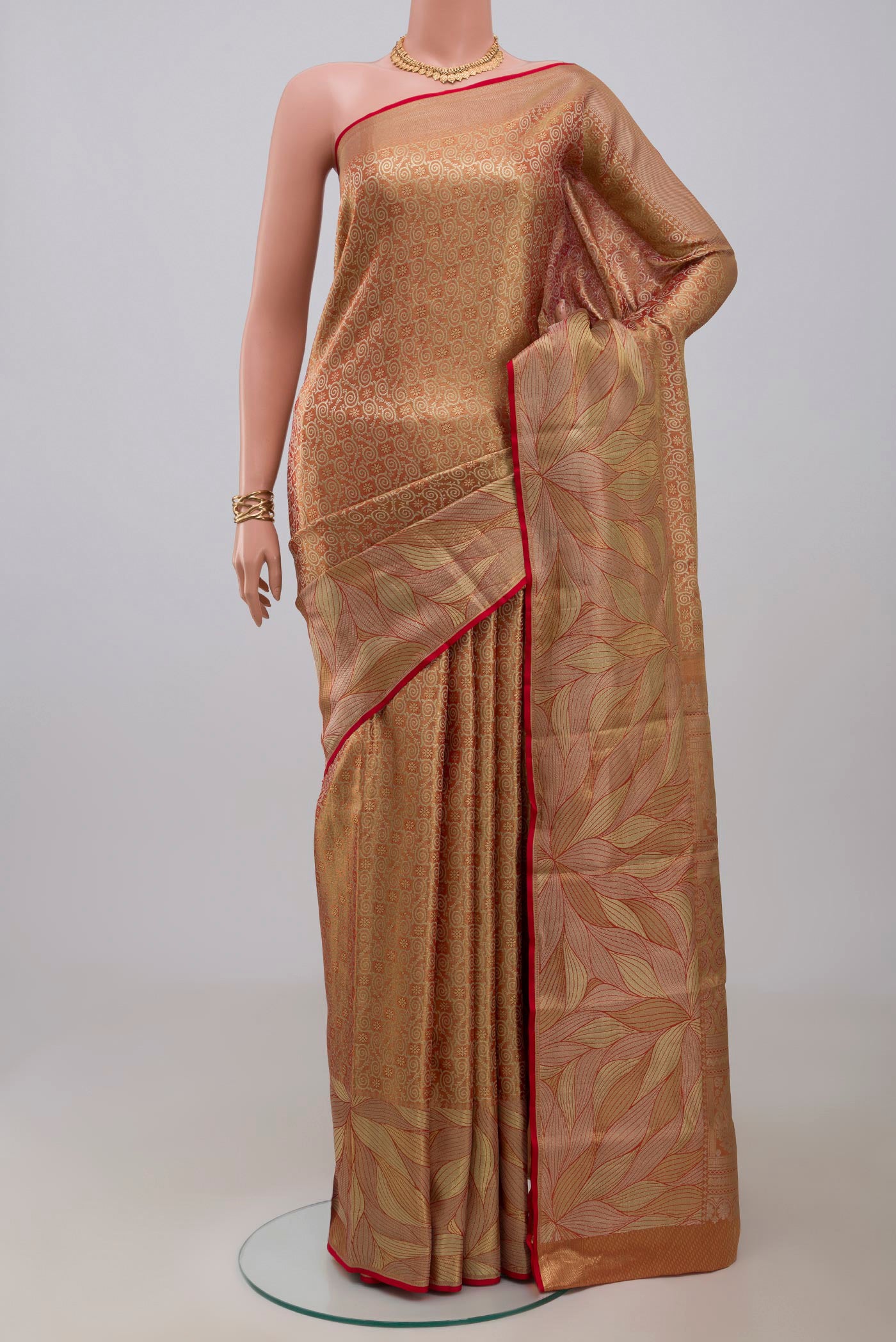 Gold with Red Color Kanchipuram Tissue Silk Saree with Zari Brocade on the body and Fancy Border.  displayed on a mannequin