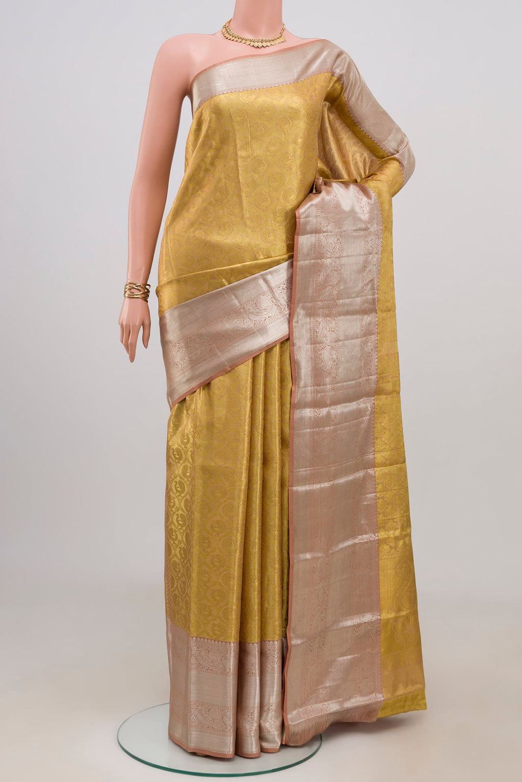 Golden Kanchipuram Tissue Silk Saree with Zari Brocade on the body and Zari Border.  displayed on a mannequin