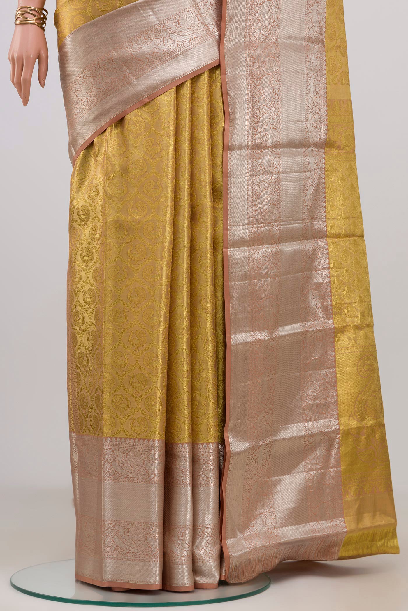 Pleats and pallu of Golden Kanchipuram Tissue Silk Saree with Zari Brocade on the body and Zari Border. 