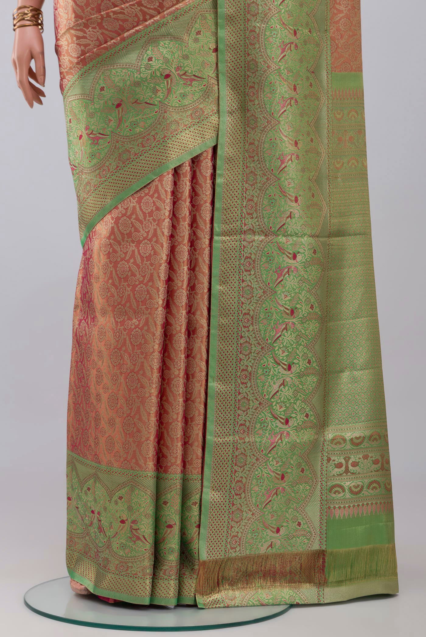 Pleats and pallu of Peach Kanchipuram Tissue Silk Saree with Zari Brocade on the body and Fancy Border. 