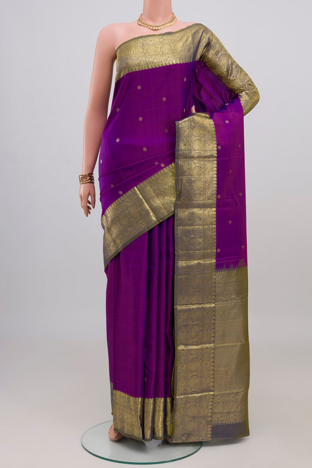 Purple Kanchipuram Silk Saree with Zari Butta on the body and Zari Border.  displayed on a mannequin