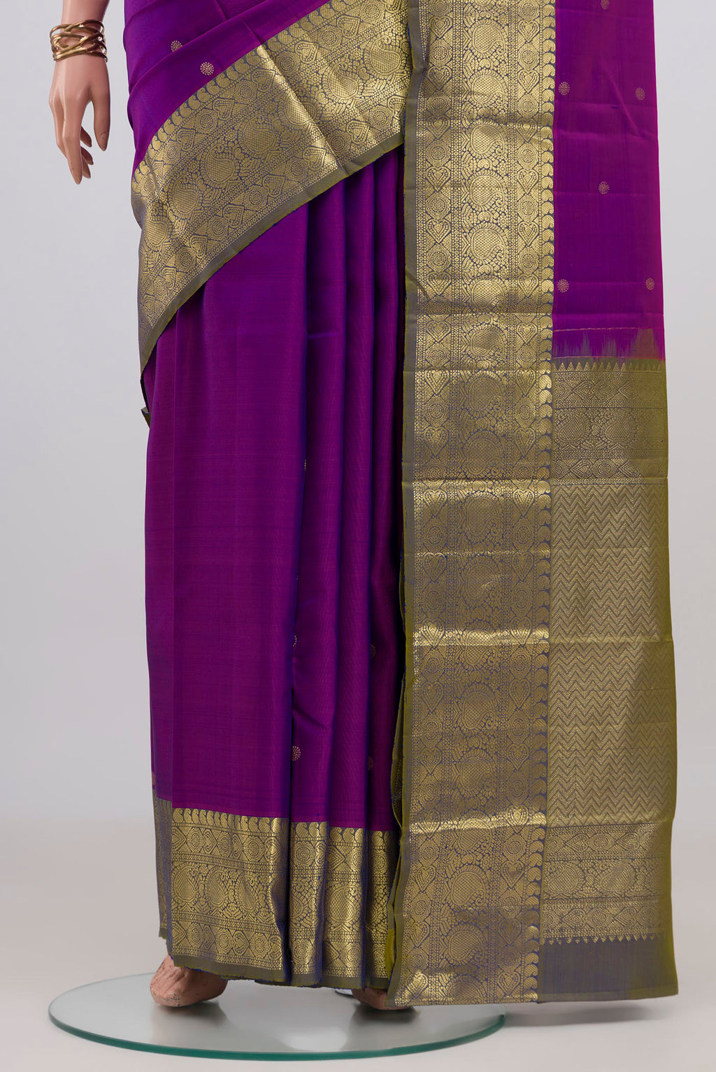 Pleats and pallu of Purple Kanchipuram Silk Saree with Zari Butta on the body and Zari Border. 