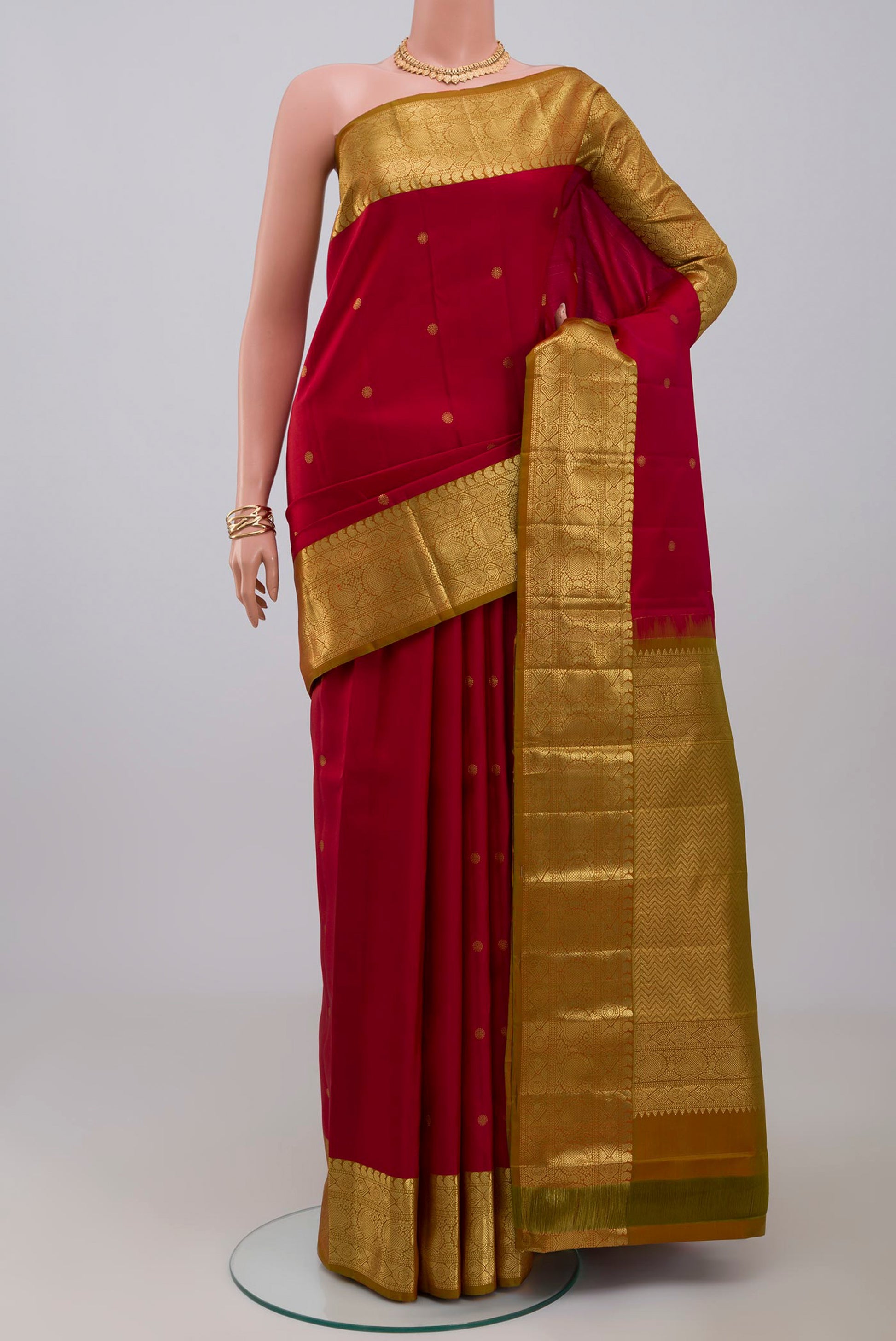 Maroon Kanchipuram Saree with Zari Butta on the body and Zari Border.  displayed on a mannequin