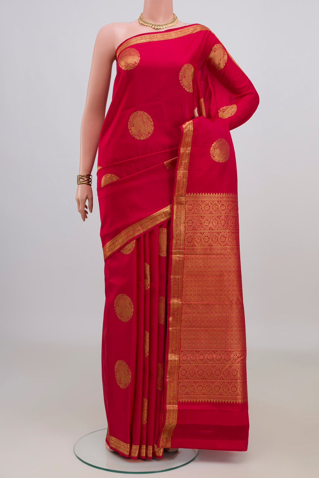 Pure Silk Red Kanchipuram Saree with Zari Butta on the body and Zari Border.  displayed on a mannequin