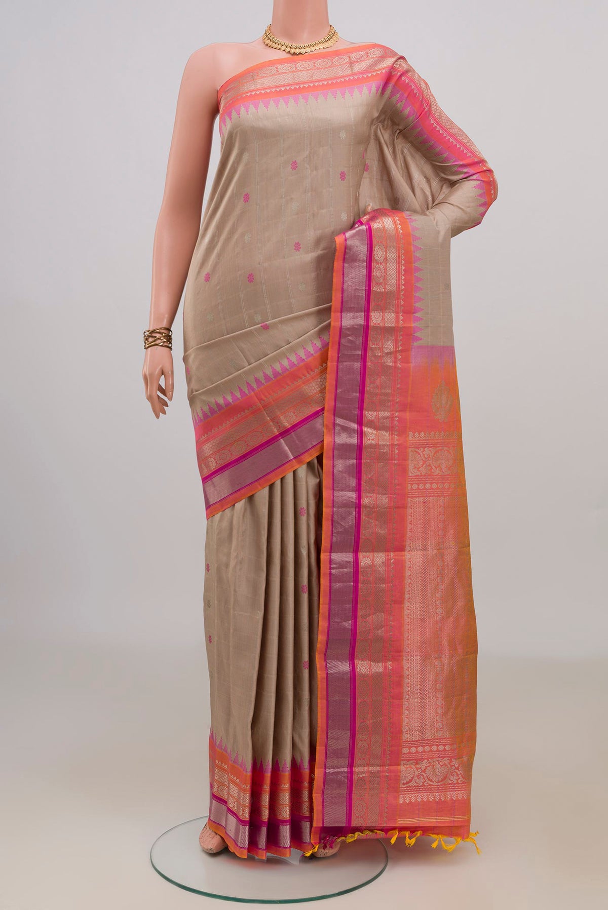 Pure Silk Beige Gadwal Saree with Zari Butta on the body and Zari Border.  displayed on a mannequin