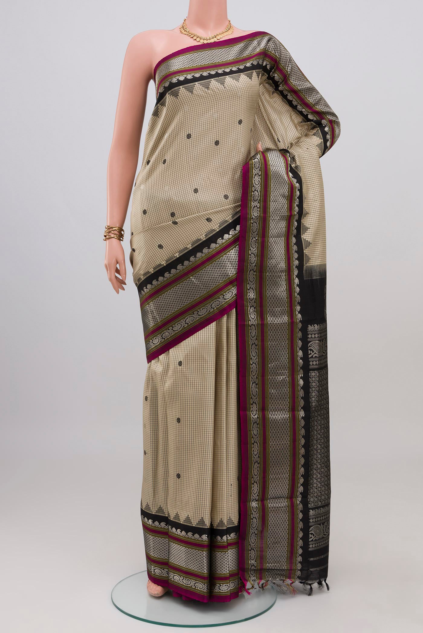 Cream Gadwal Silk Saree with Checked design on the body and Zari Border.  displayed on a mannequin