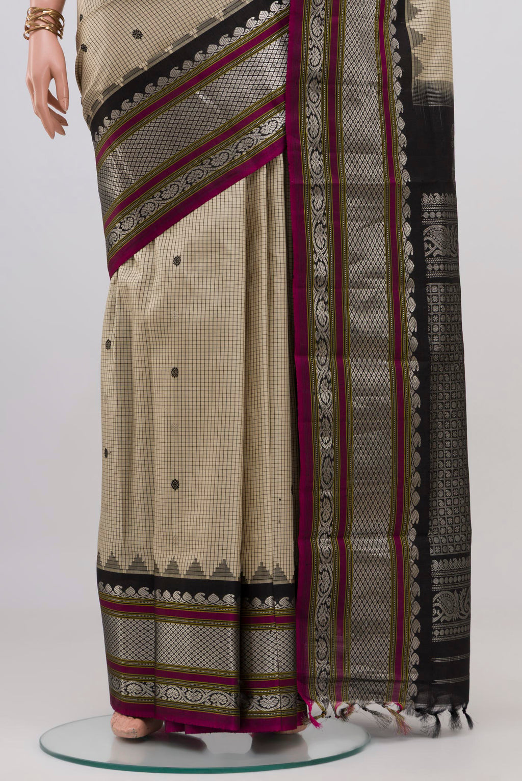 Pleats and pallu of Cream Gadwal Silk Saree with Checked design on the body and Zari Border. 