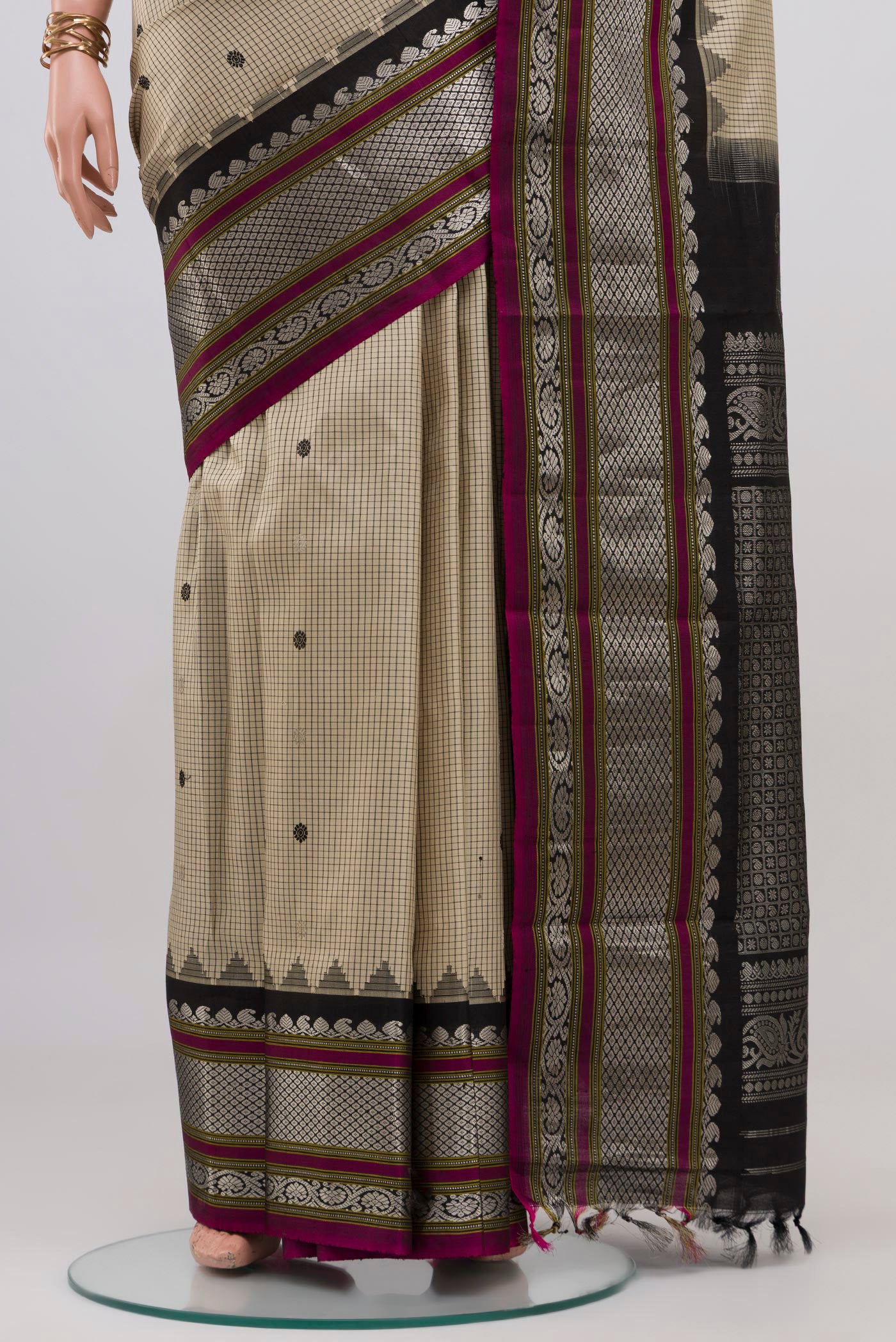 Pleats and pallu of Cream Gadwal Silk Saree with Checked design on the body and Zari Border. 