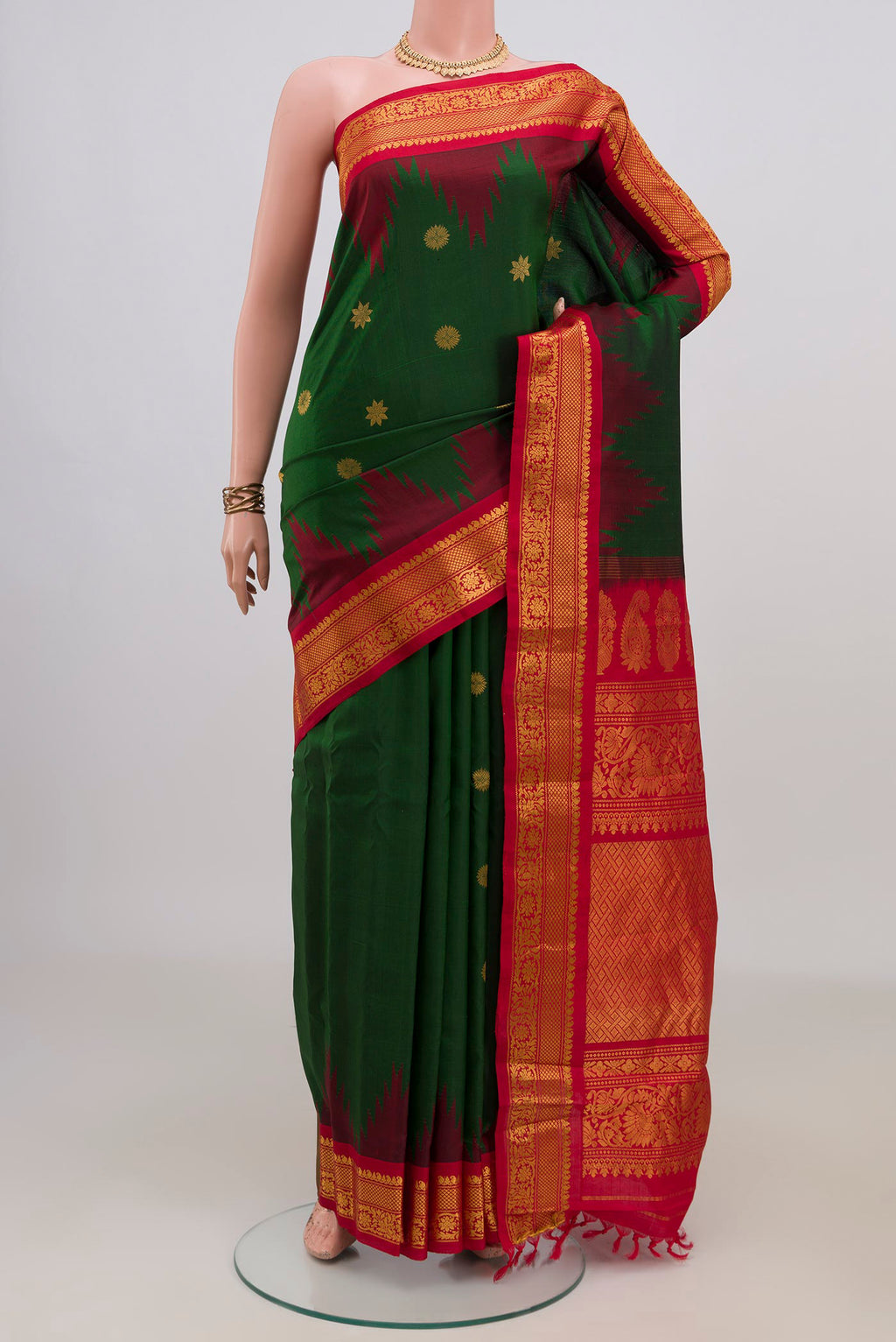 Pure Silk Bottle Green Gadwal Saree with Zari Butta on the body and Zari Border.  displayed on a mannequin