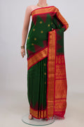 Pure Silk Bottle Green Gadwal Saree with Zari Butta on the body and Zari Border.  displayed on a mannequin