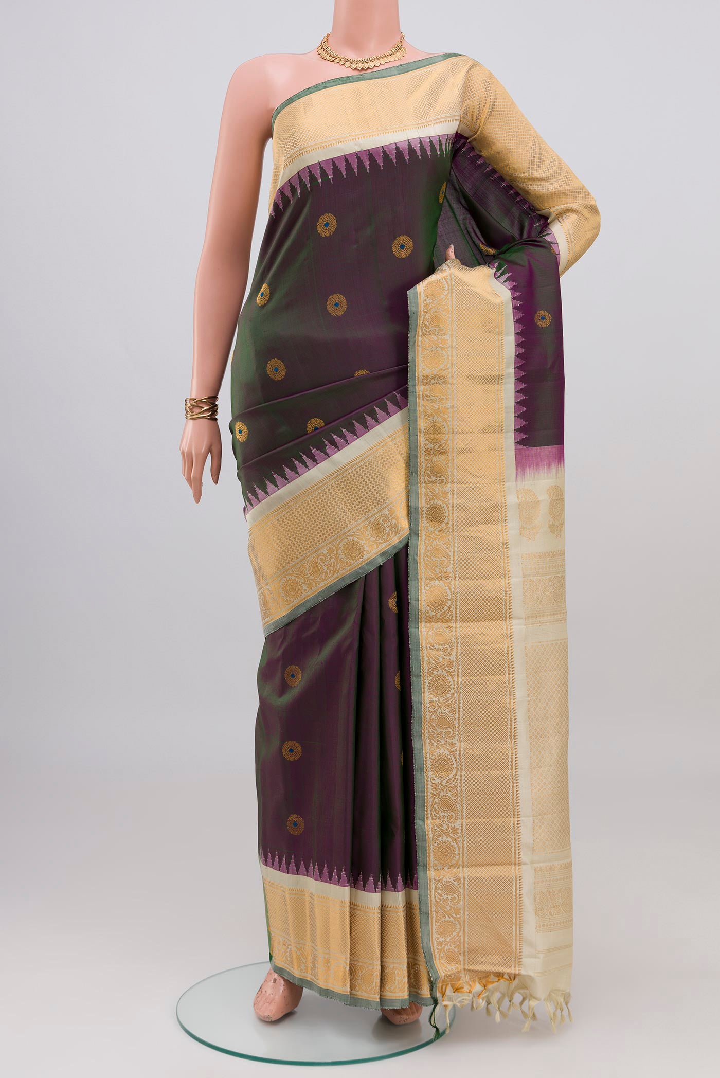Green Dual Tone Gadwal Silk Saree with Zari Butta on the body and Zari Border.  displayed on a mannequin