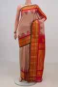 Pure Silk Peach Gadwal Saree with Zari Butta on the body and Zari Border.  displayed on a mannequin
