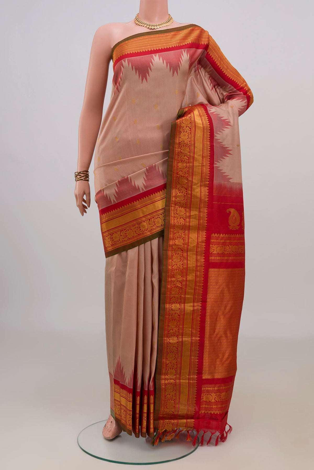 Pure Silk Peach Gadwal Saree with Zari Butta on the body and Zari Border.  displayed on a mannequin