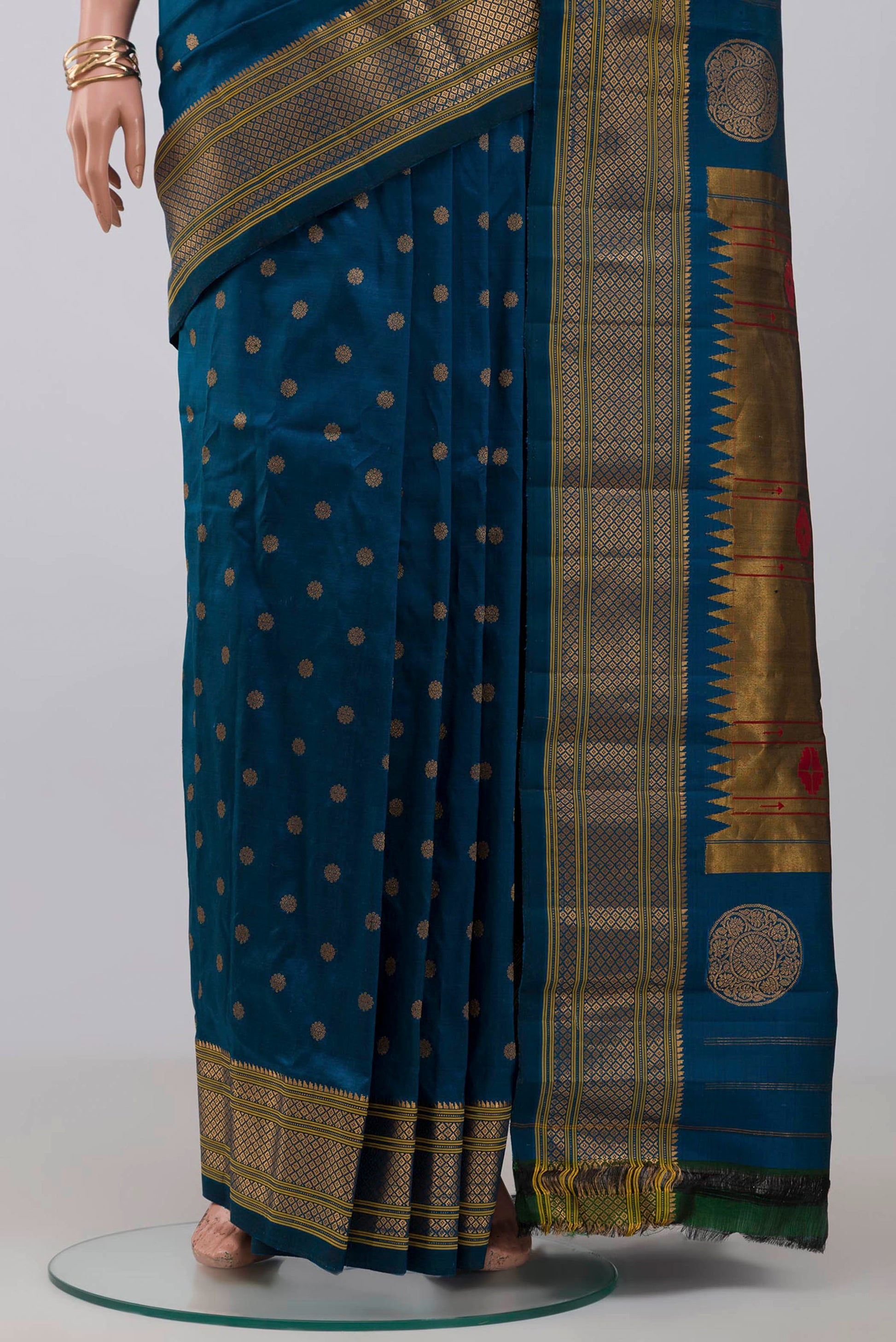 Pleats and pallu of Blue Gadwal Silk Saree with Zari Butta on the body and Zari Border. 