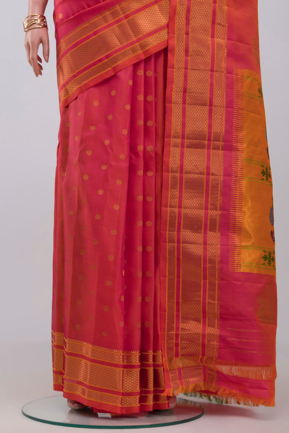 Pleats and pallu of Orange Dual Tone Gadwal Silk Saree with Zari Butta on the body and Zari Border. 