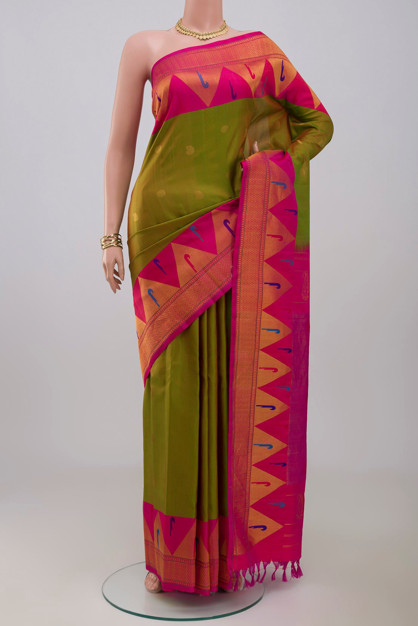 Green Gadwal Silk Saree with Zari Butta on the body and Paithani Border.  displayed on a mannequin