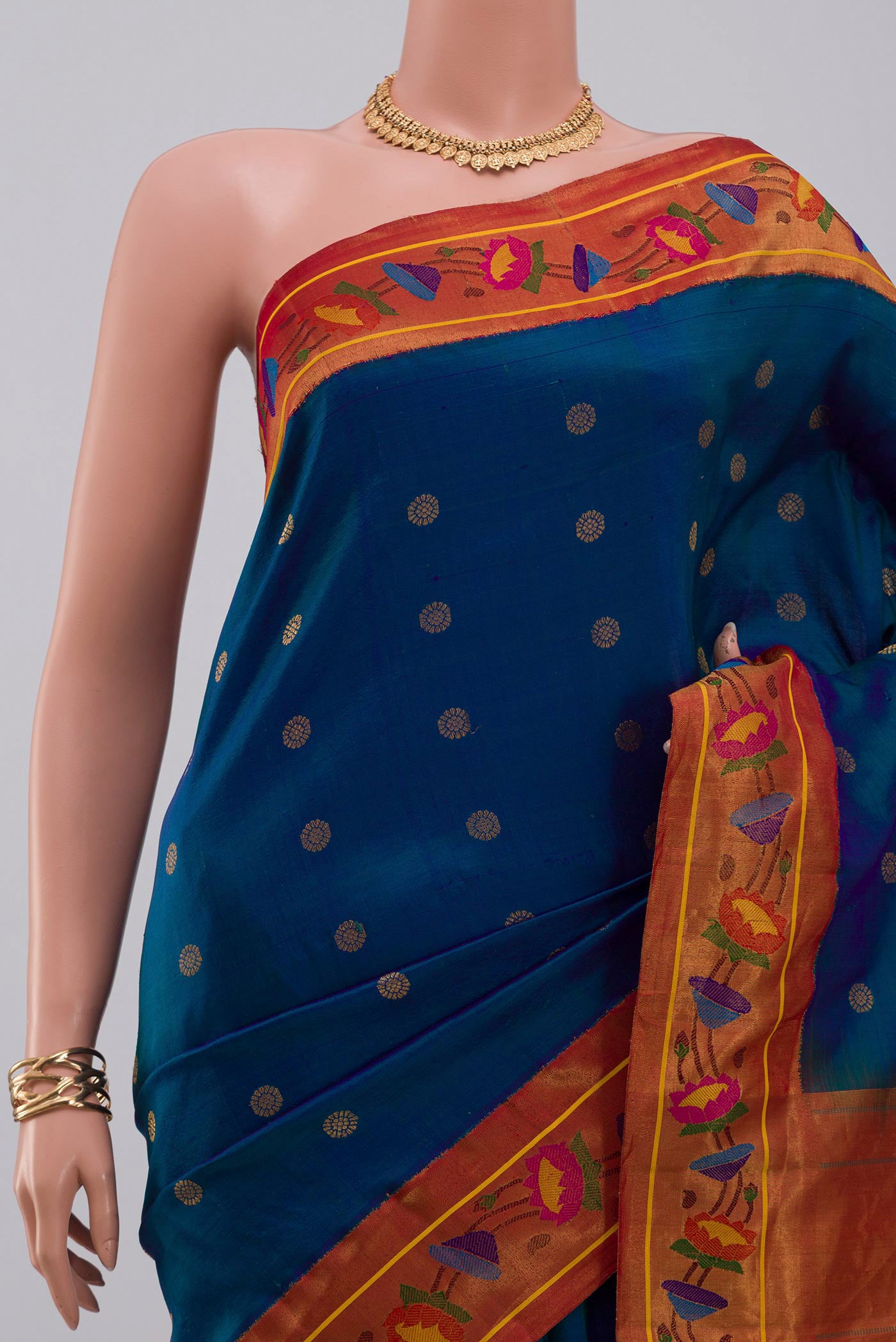 Border image of Blue Gadwal Silk Saree with Zari Butta on the body and Paithani Border. 