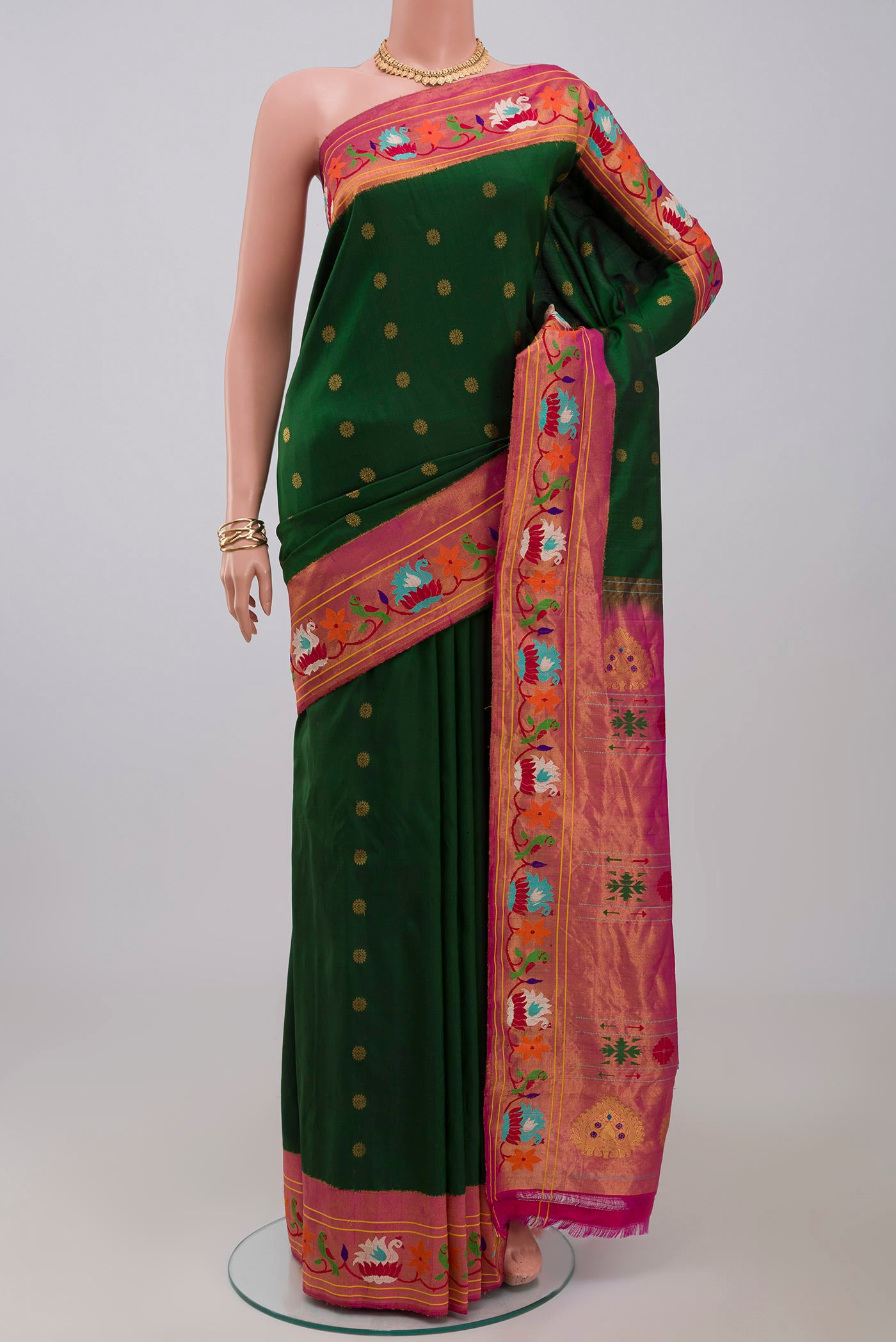 Green Gadwal Silk Saree with Zari Butta on the body and Paithani Border.  displayed on a mannequin