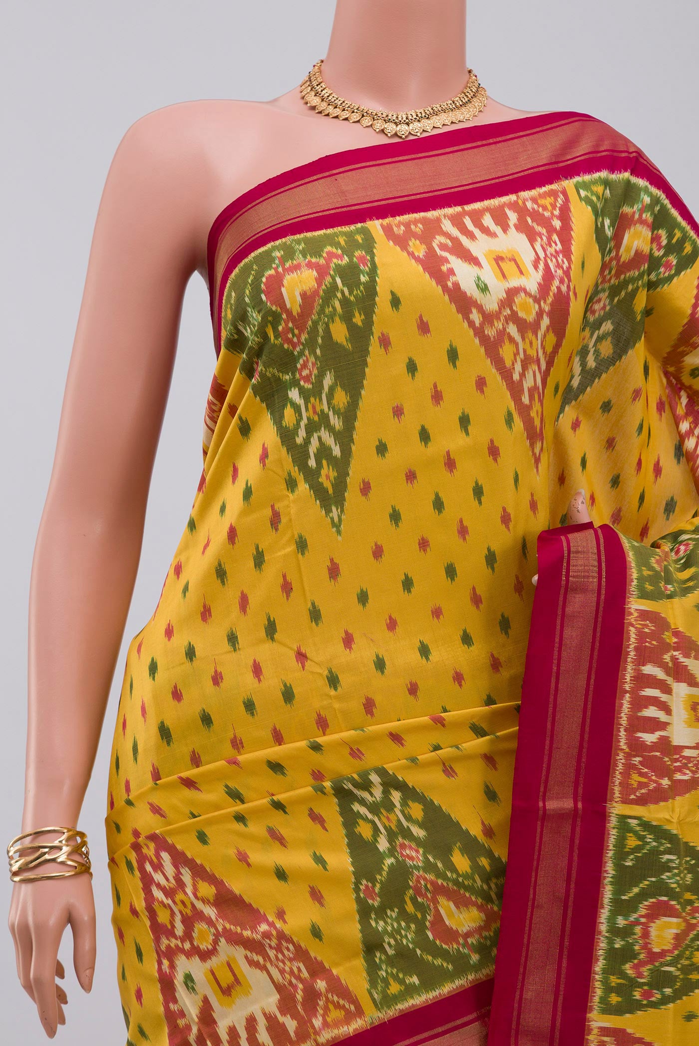 Border image of Yellow Pochampally Silk Saree with Ikat design on the body and Thin Zari Line. 