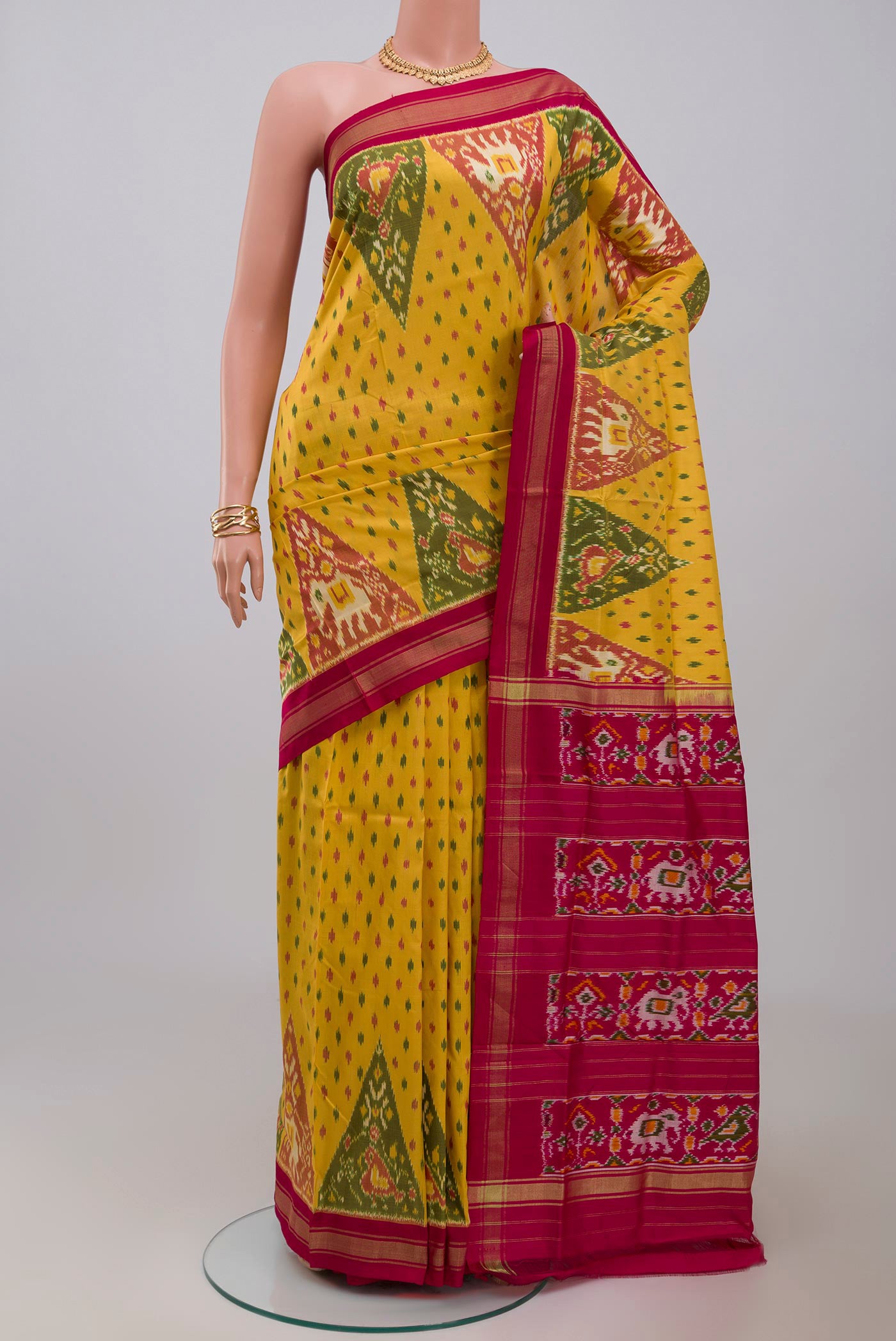 Yellow Pochampally Silk Saree with Ikat design on the body and Thin Zari Line.  displayed on a mannequin