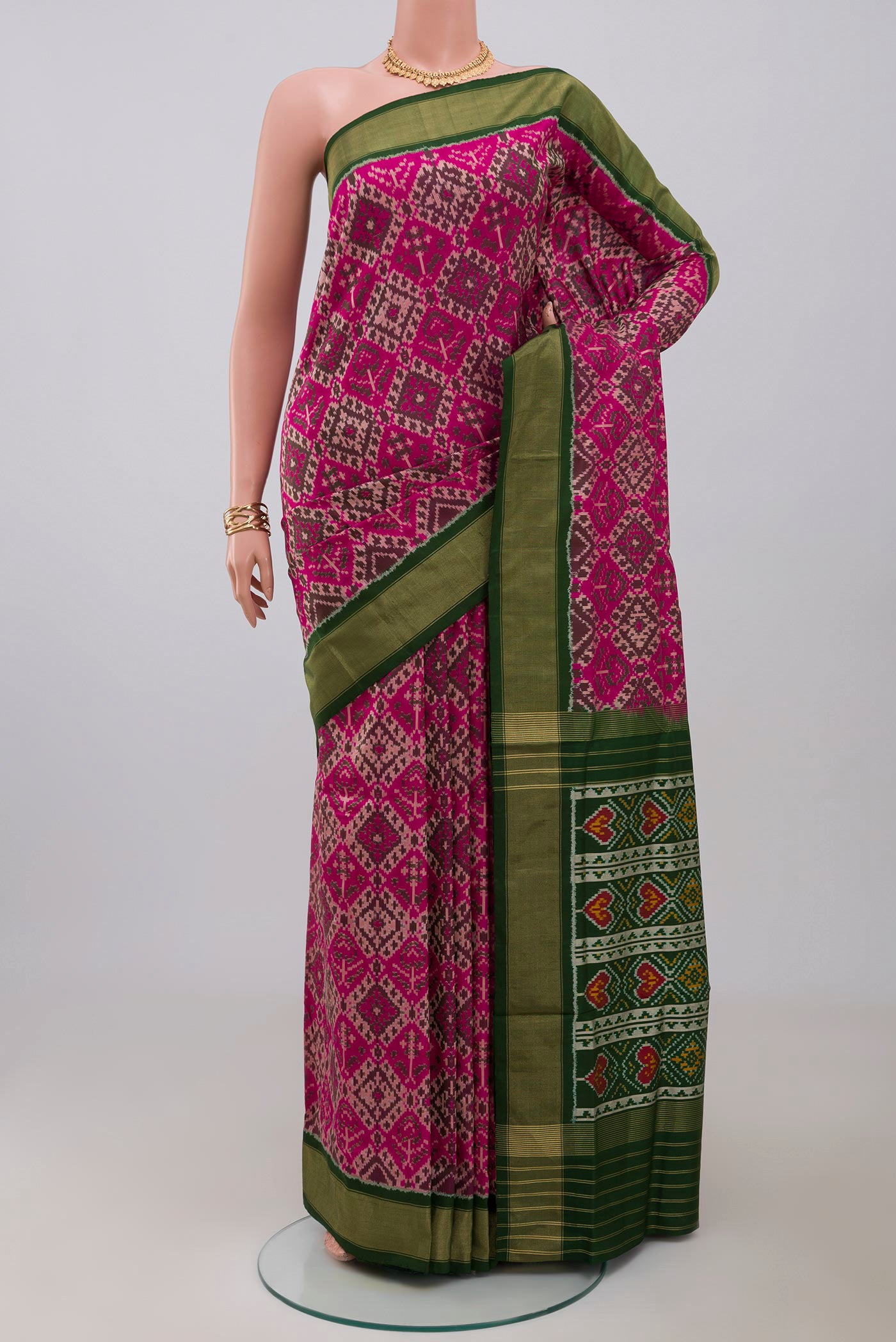 Pink Pochampally Saree with Ikat Print on the body and Zari Border.  displayed on a mannequin
