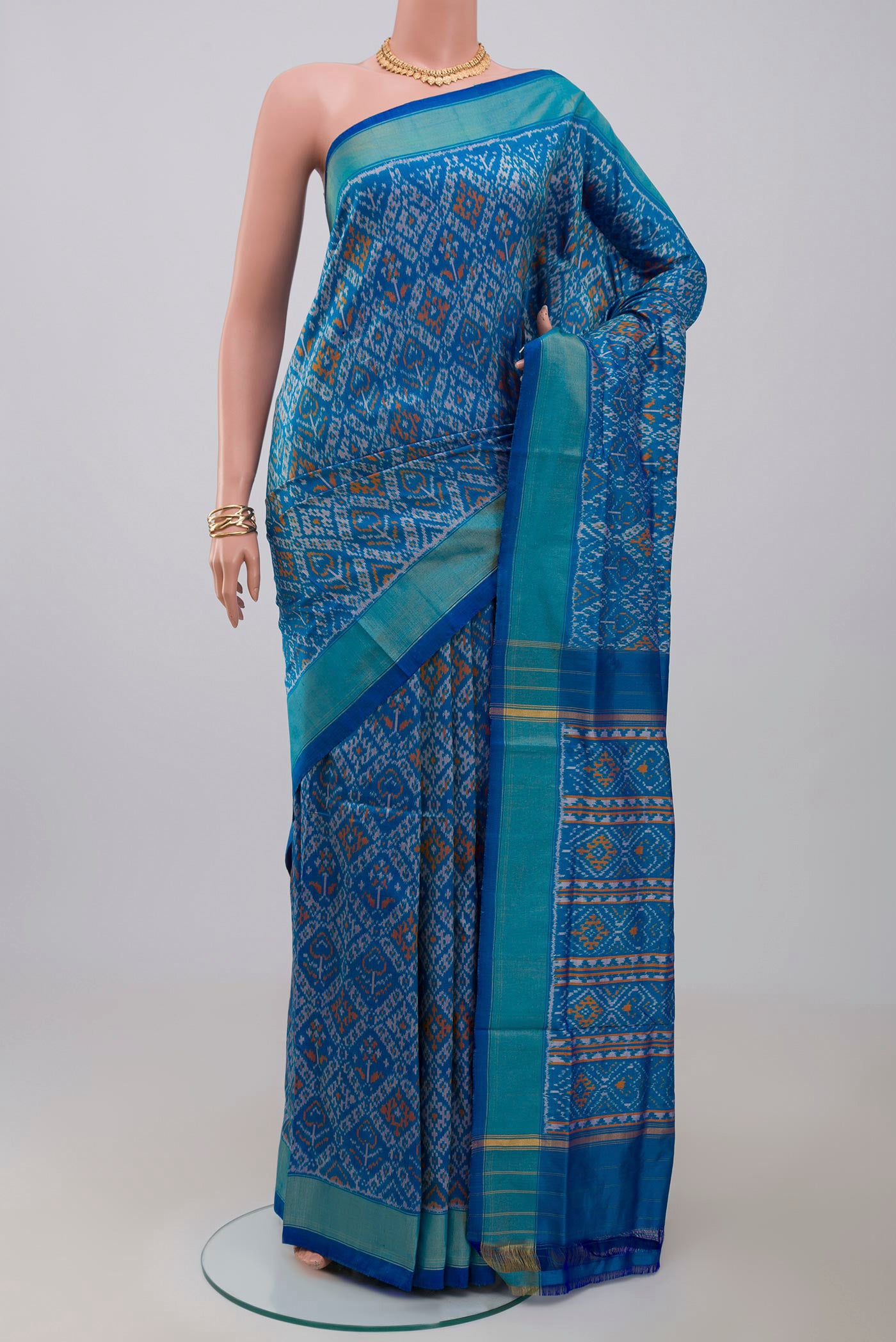 Blue Pochampally Silk Saree with Ikat design on the body and Zari Border.  displayed on a mannequin