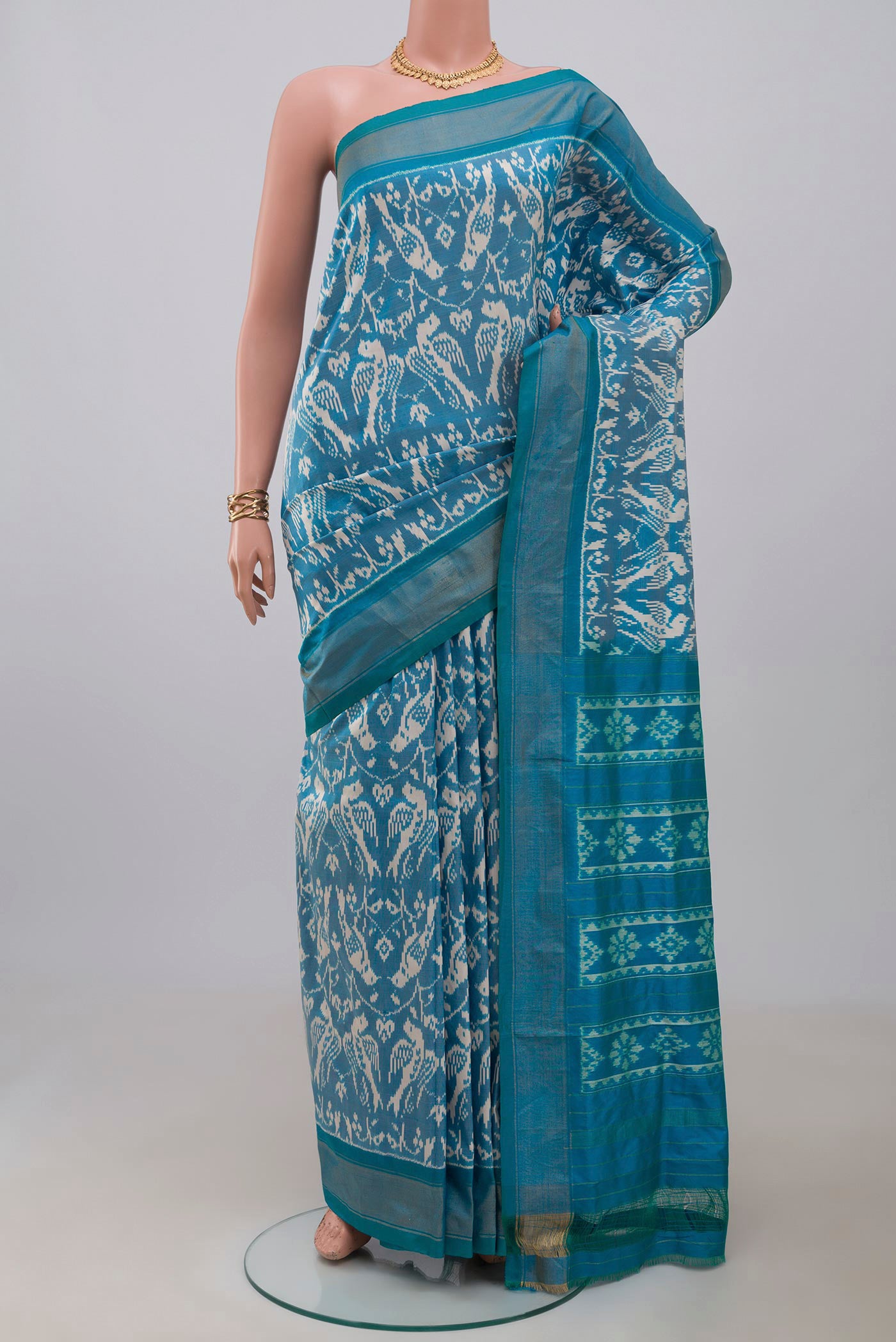 Sky Blue Pochampally Saree with Ikat design on the body and Zari Border.  displayed on a mannequin