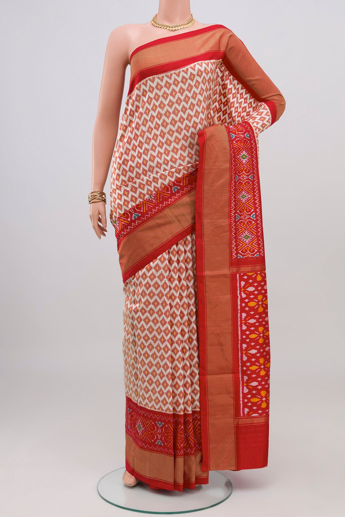Cream Pochampally Saree with Ikat design on the body and Ikat Border.  displayed on a mannequin
