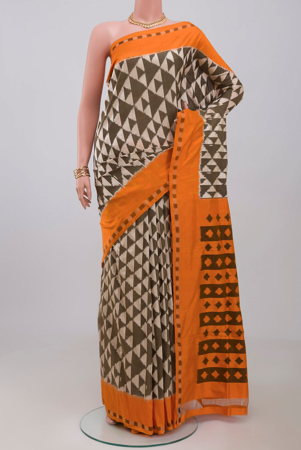 Cream Pochampally Silk Saree with Ikat design on the body and Plain Border.  displayed on a mannequin