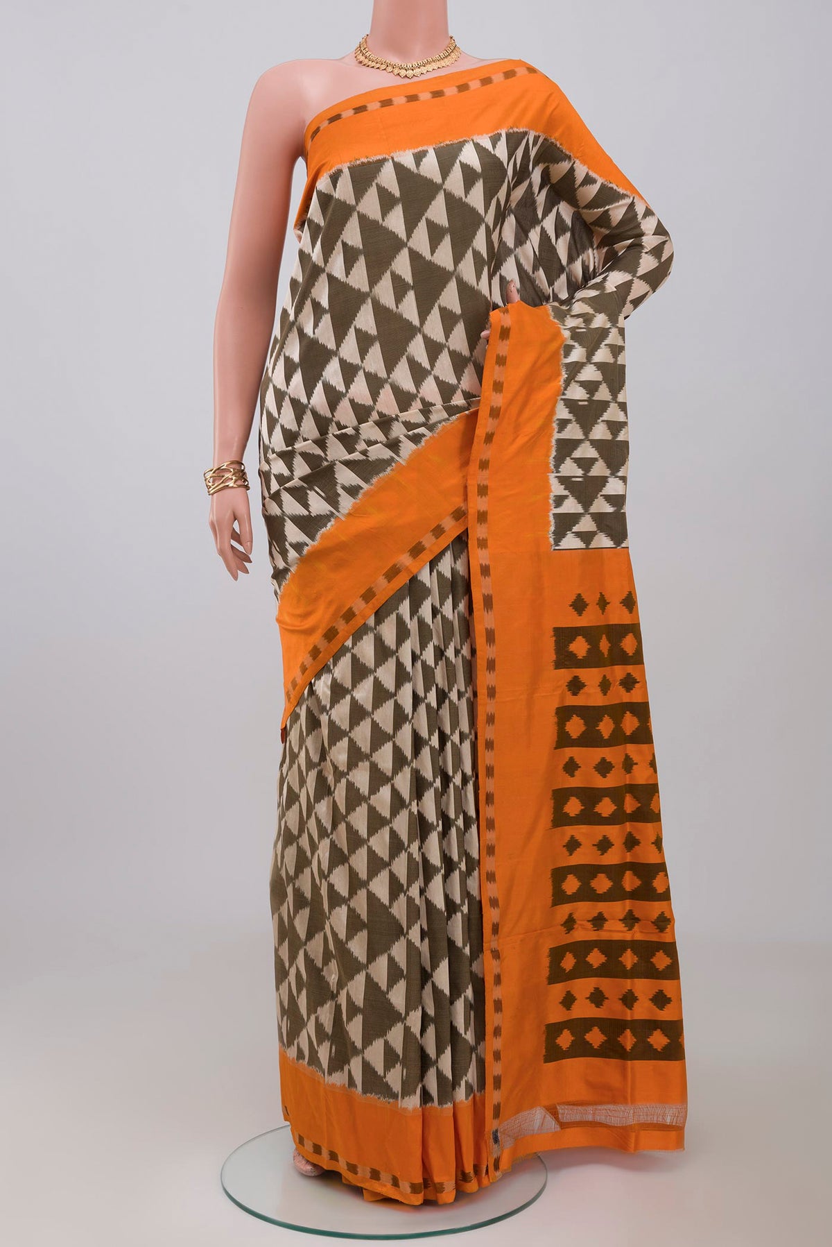 Cream Pochampally Silk Saree with Ikat design on the body and Plain Border.  displayed on a mannequin