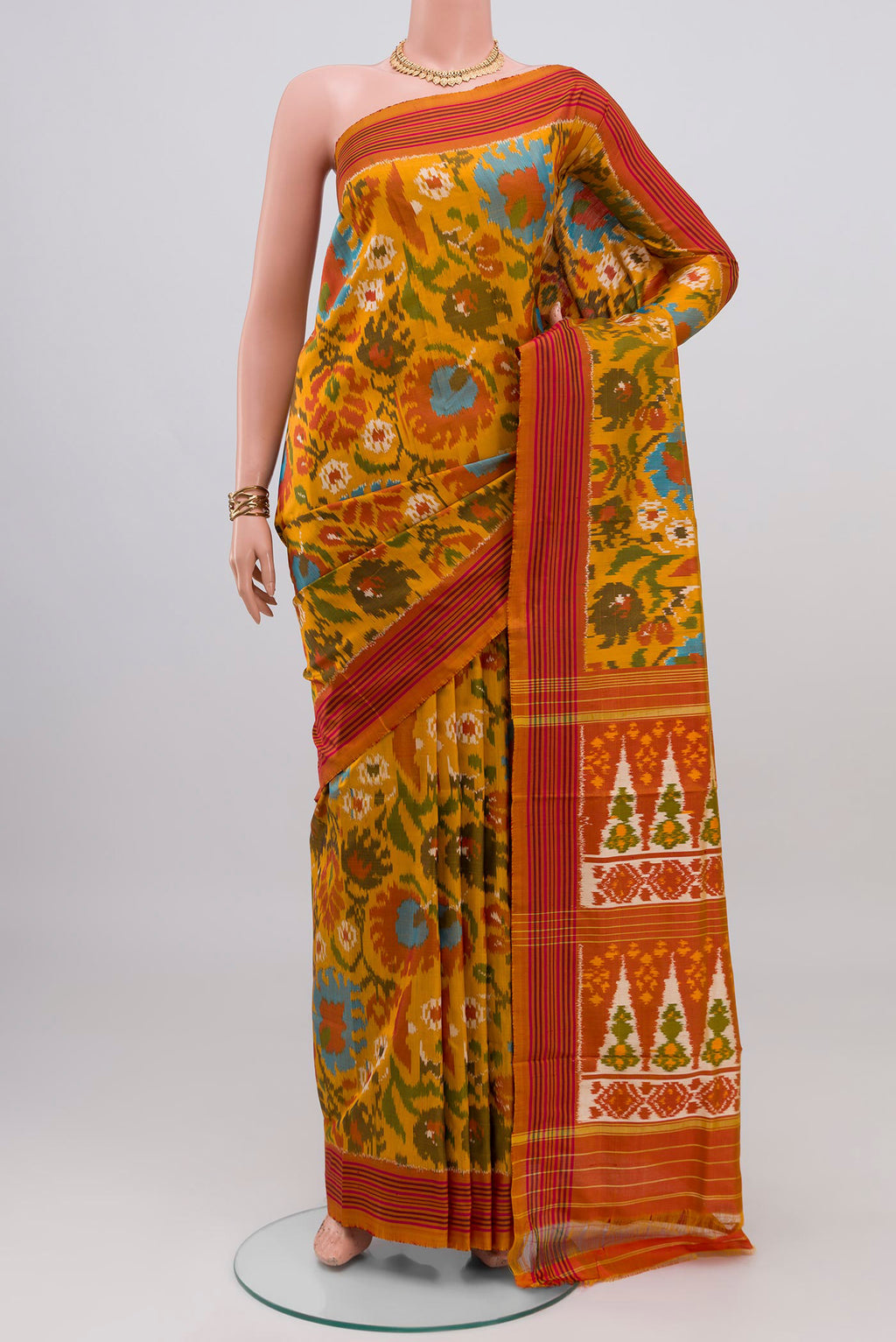 Mustard Pochampally Silk Saree with Ikat design on the body and Plain Border.  displayed on a mannequin