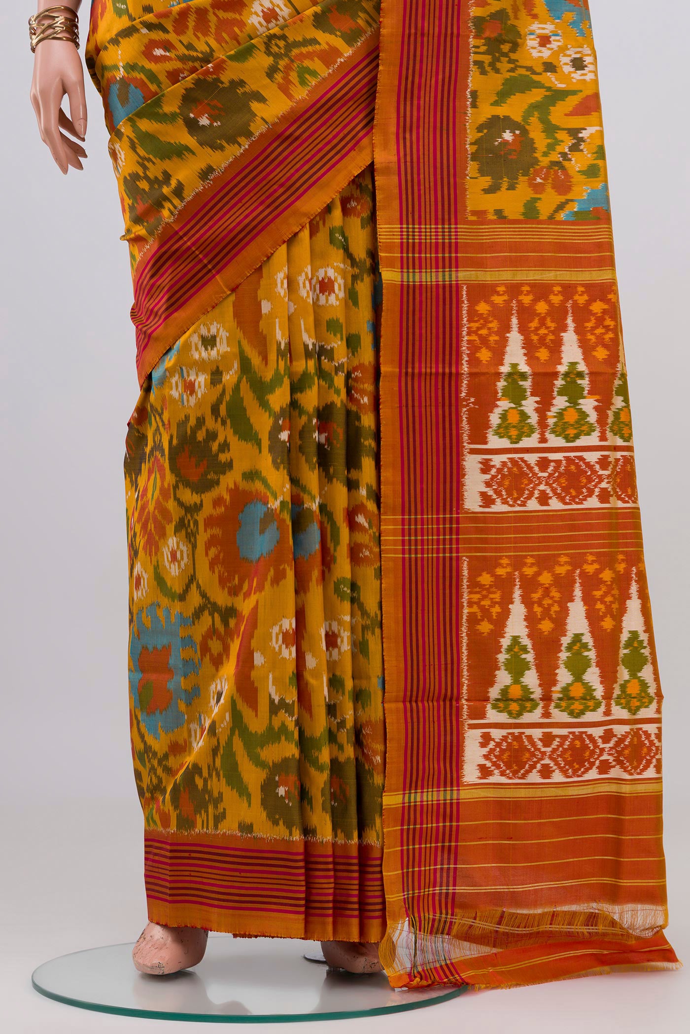 Pleats and pallu of Mustard Pochampally Silk Saree with Ikat design on the body and Plain Border. 