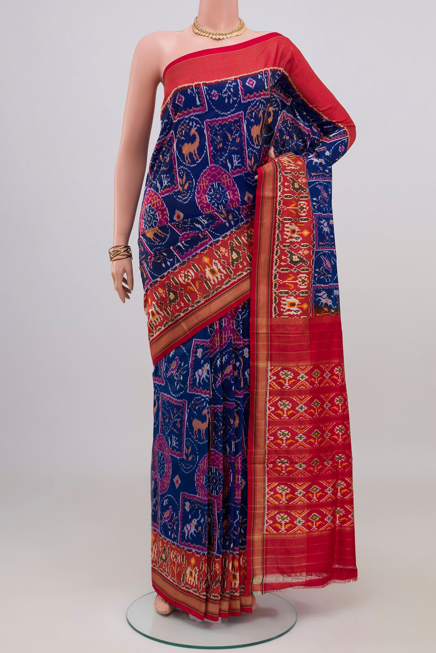 Blue Pochampally Silk Saree with Ikat design on the body and Zari Border.  displayed on a mannequin